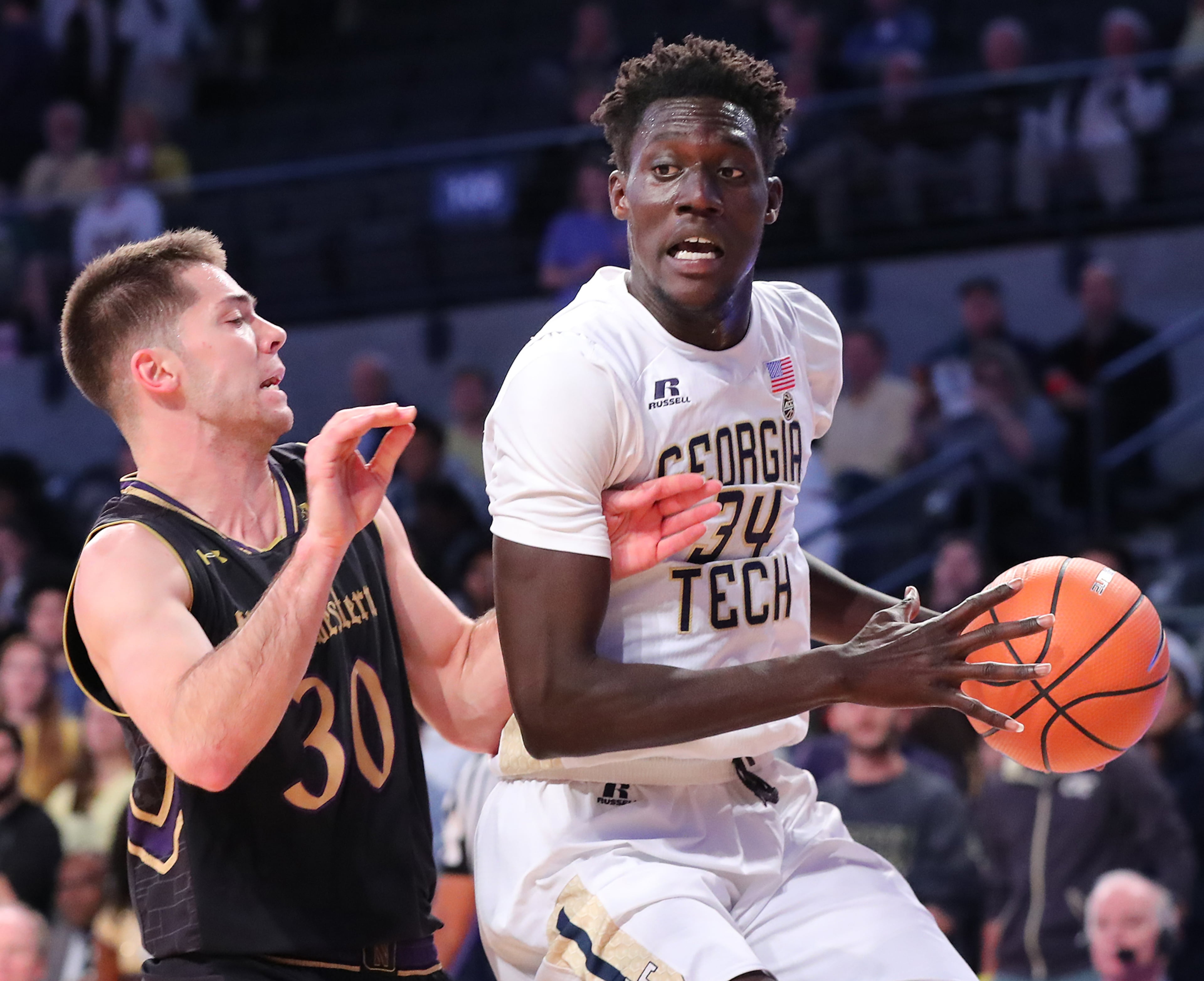 November 28, 2017 Atlanta: Georgia Tech forward Abdoulaye Gueye works to the basket against Northwestern guard Bryant McIntosh in a NCAA college basketball game on Tuesday, November 28, 2017, in Atlanta. Curtis Compton/ccompton@ajc.com