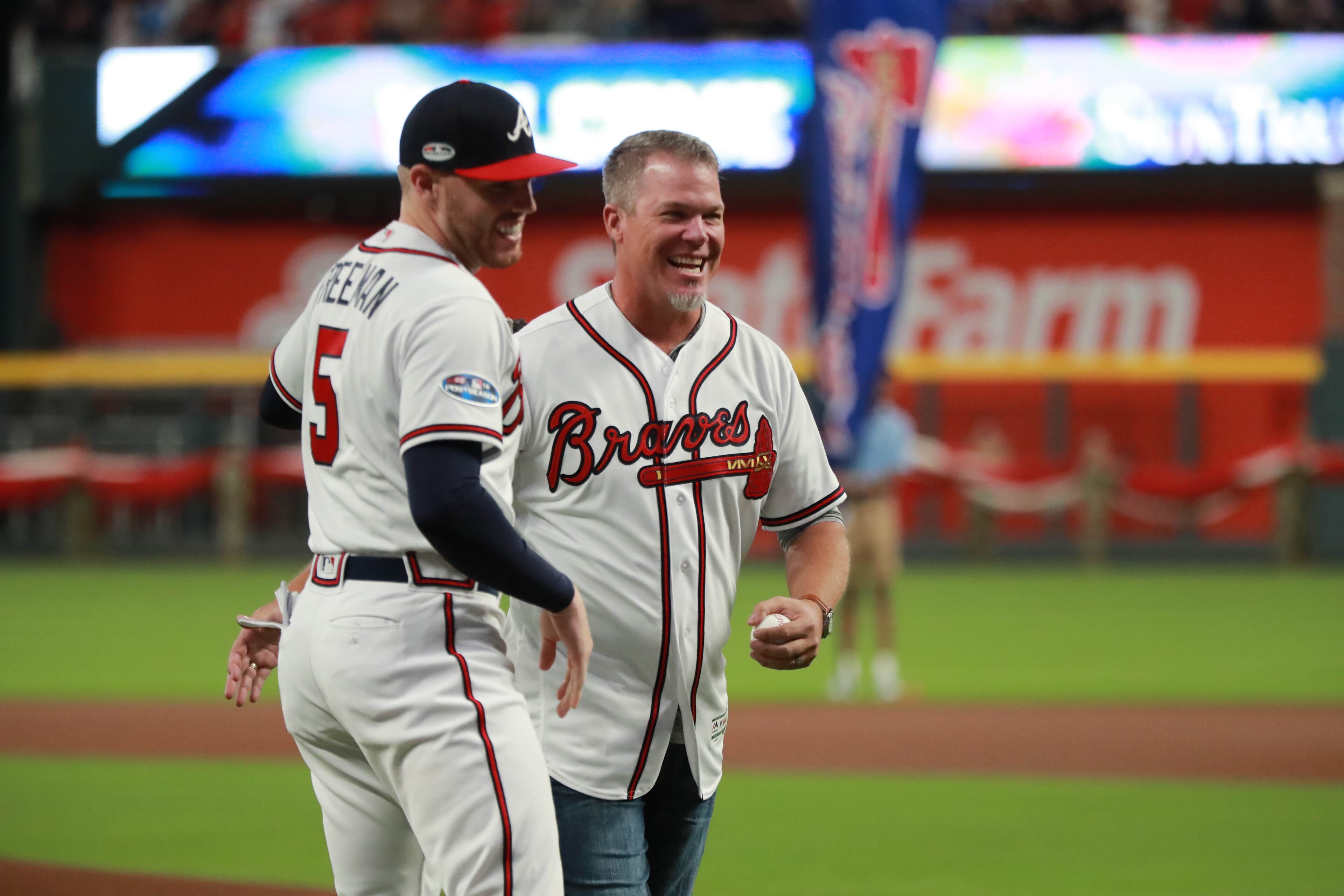 Former Atlanta Braves third baseman Chipper Jones greets first baseman Freddie Freeman after Jones threw out the first pitch before the start of their game against the Los Angeles Dodgers in Game 3 of a National League Division Series baseball game Sunday, October 7, 2018, in Atlanta. Curtis Compton/ccompton@ajc.com
