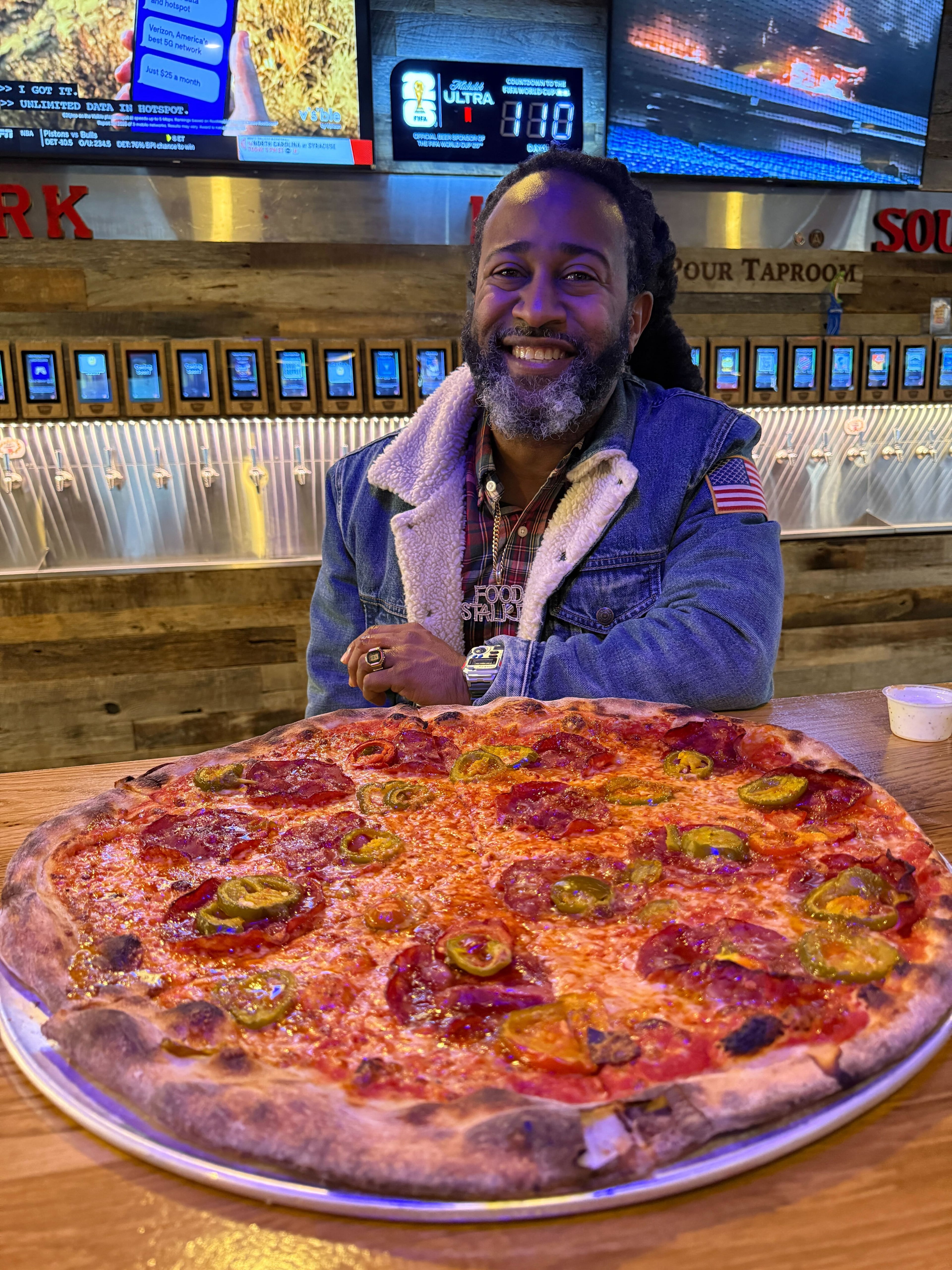 Justin Brown, aka @therealfoodstalker, enjoys a pie at Pizza Dynamo in Atlanta. (Justin Brown for the AJC)