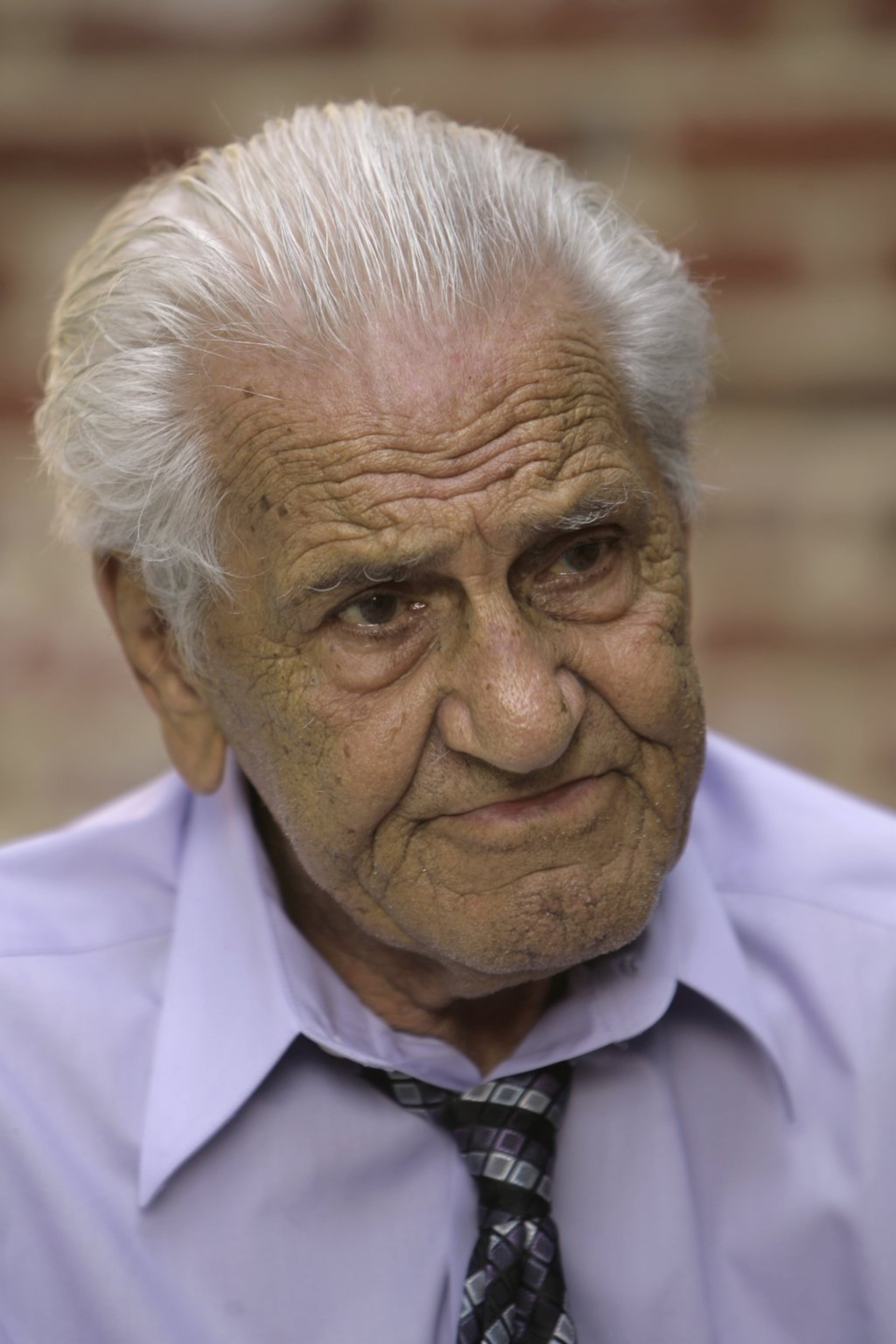 Despite the popularity of the "Band of Brothers" series, William "Wild Bill" Guarnere, shown here during an interview with the Associated Press in Broomall, Pa. in 2007, was never able to get one of his companions to attend his reunions--Dewitt Lowrey. (AP Photo/Matt Rourke)