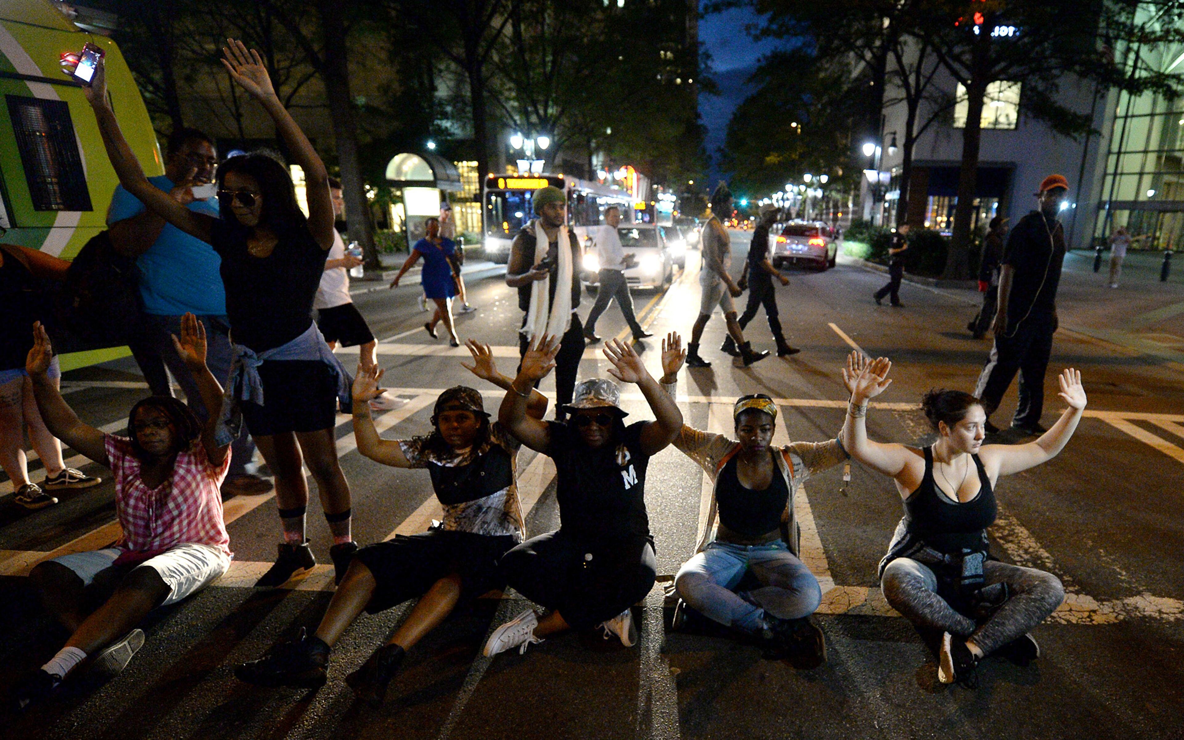 Protesters block an intersection at Trade and Tryon Streets in Charlotte, N.C., on Wednesday, Sept. 21, 2016. The protestors were rallying against the fatal shooting of Keith Lamont Scott by police on Tuesday evening in the University City area. (Jeff Siner/The Charlotte Observer/TNS)