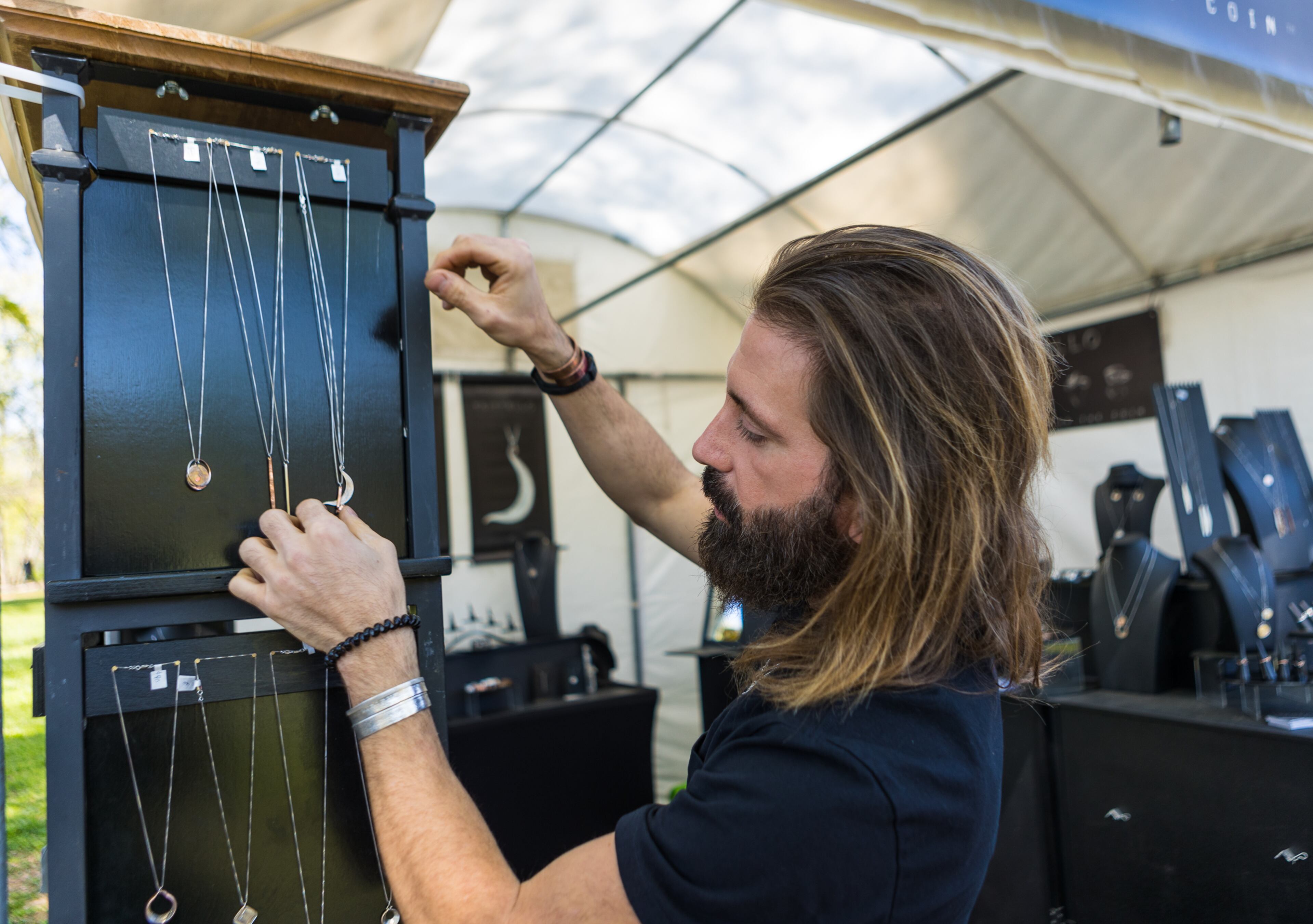 Michael Bonardi displays his jewelry in his Trittello booth at the 86th annual Atlanta Dogwood Festival in Piedmont Park on April 10, 2022. (Jenni Girtman for The Atlanta Journal-Constitution)