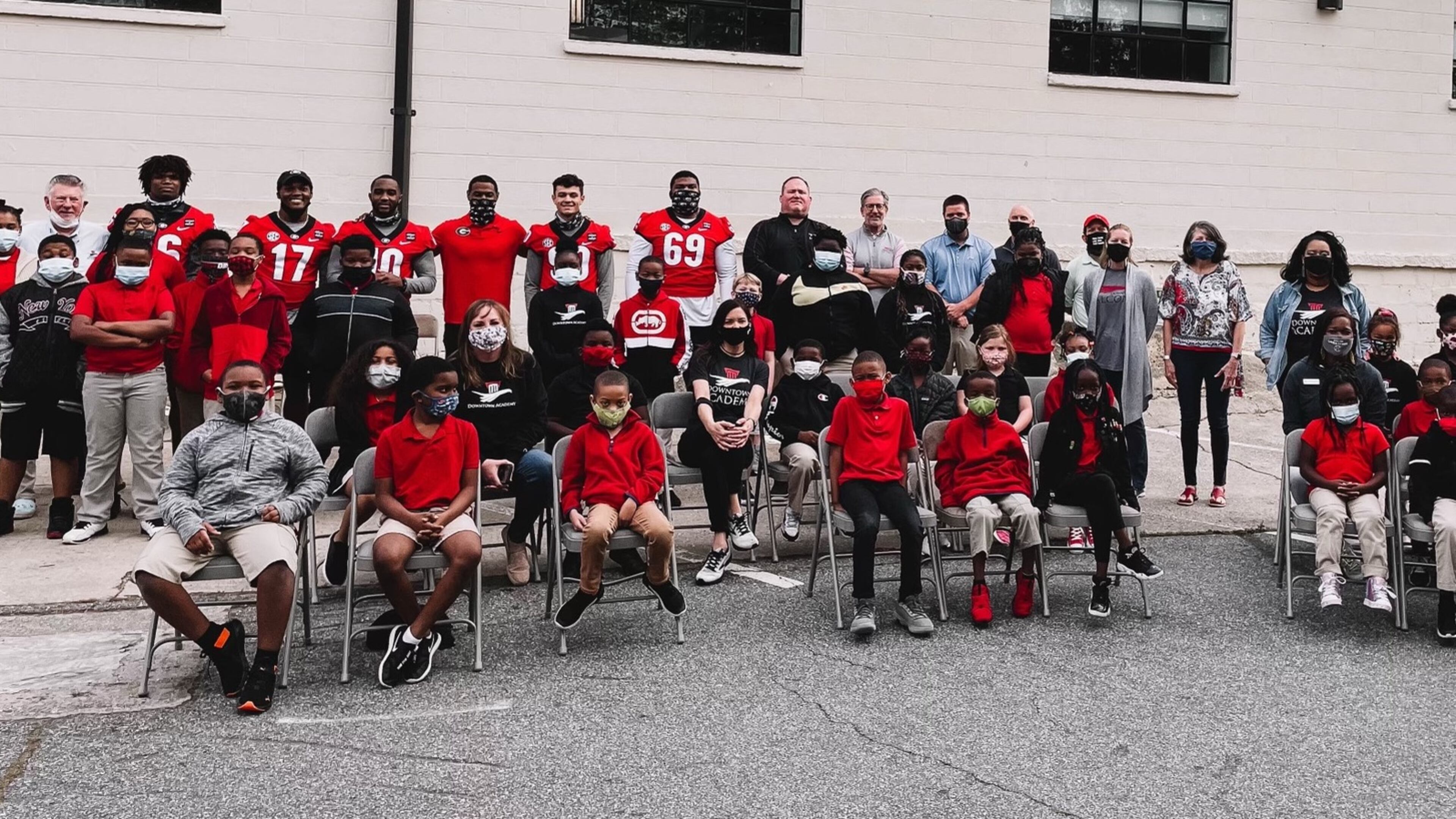 The students from Downtown Academy couldn't all fit in a photo with Georgia football players Lewis Cine (16), Nakobe Dean (17), Kearis Jackson (10), receivers coach Cortez Hankton, Jake Camarda (90) and Jamaree Salyer (69) when they dropped off a check for $100,000 on Thursday. The money was the proceeds from Saturday's G-Day Intrasquad game, which will be attended by more the 20,000 fans on Saturday, April 17, 2021. (Photo by UGA Athletics)