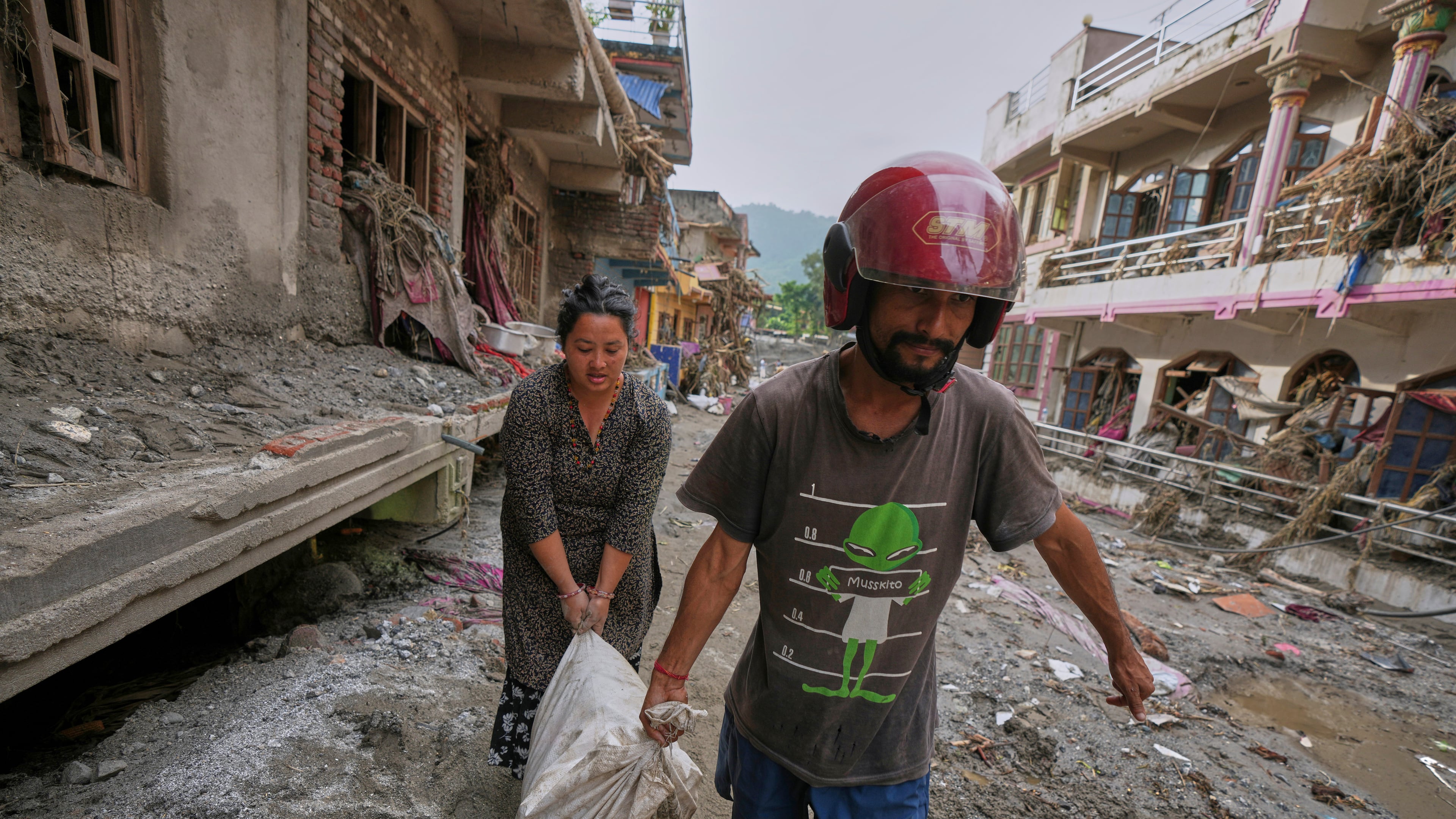 Residents salvage their belongings from damaged houses after flash flooding in the Devighat area of Nuwakot district in Nepal, Friday, Aug. 28, 2026. (AP Photo/Rajesh Kumar Singh)