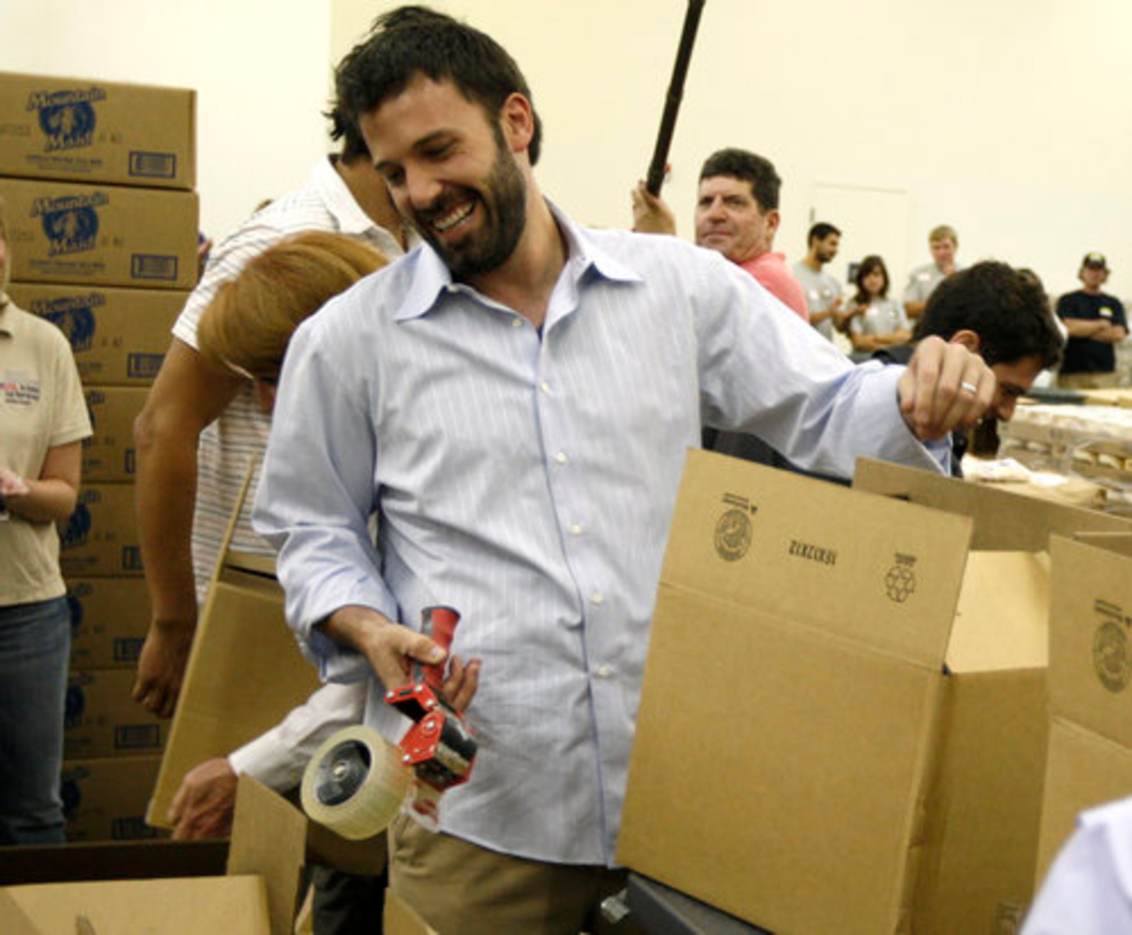 CORRUGATED CHAMP: Ben Affleck smiles during a box packing competition at the America's Second Harvest Send Hunger event in Denver. In a five-minute contest to see who could pack and wrap the most, Affleck and his team whipped the Congressional squad 17 boxes to 15. Affleck's face won't appear on a Wheaties box for his win. That's reserved for gold-medal winners.