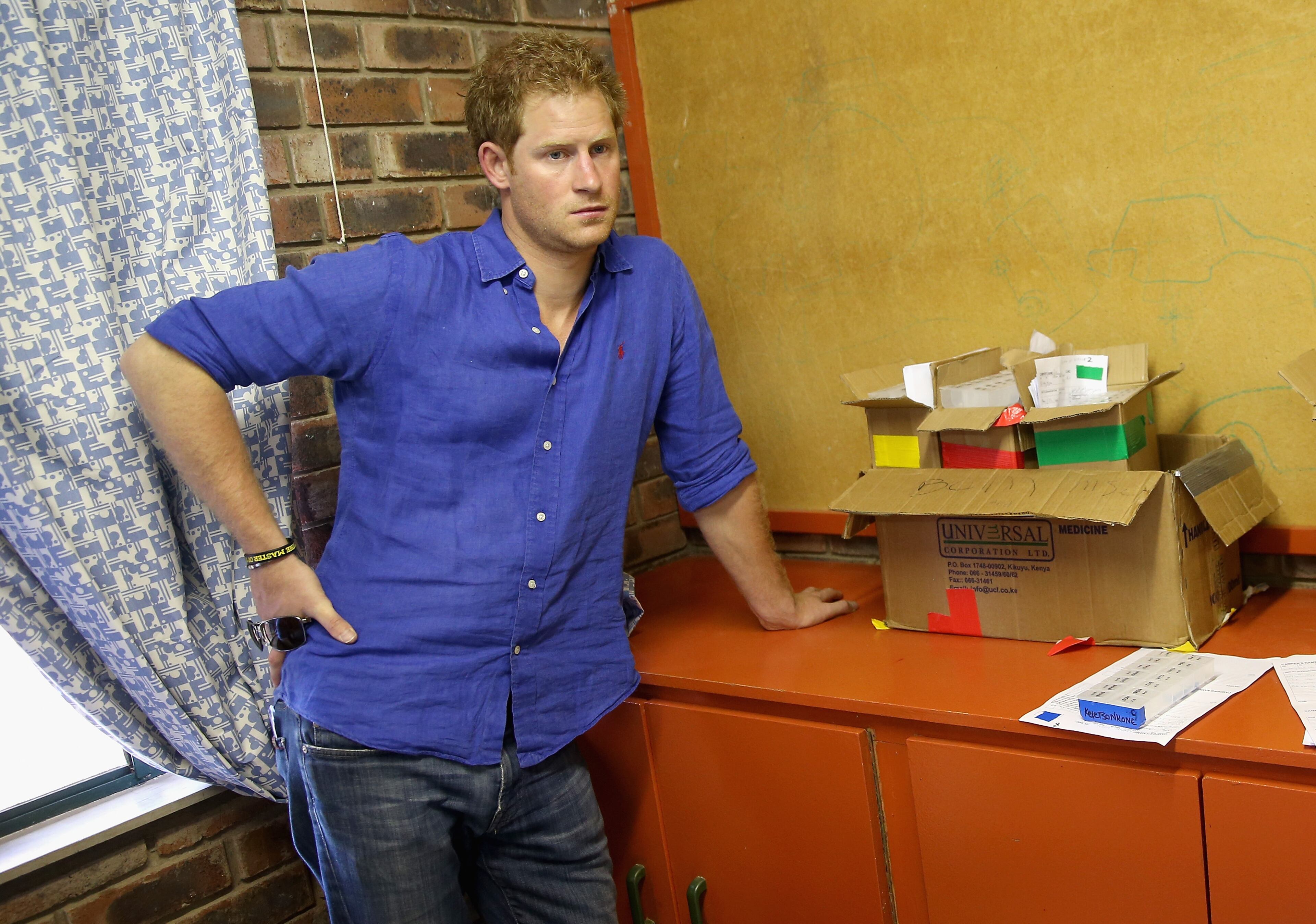 Prince Harry is shown anti-retroviral drugs at a Mamohato Network Club for children living with HIV at St Paul Centre on December 9, 2014 in Maseru, Lesotho. Prince Harry was visiting Lesotho to see the work of his charity Sentebale. Sentebale provides healthcare and education to vulnerable children in Lesotho, Southern Africa. The particular theme of his visit was to check on the progress of the Mamohato Childrens Centre which will provide vital support to children affected by HIV. Prince Harry founded Sentebale (which means Forget Me Not in Sesotho) with Prince Seeiso in 2006. (Photo by Chris Jackson/Getty Images for Sentebale)