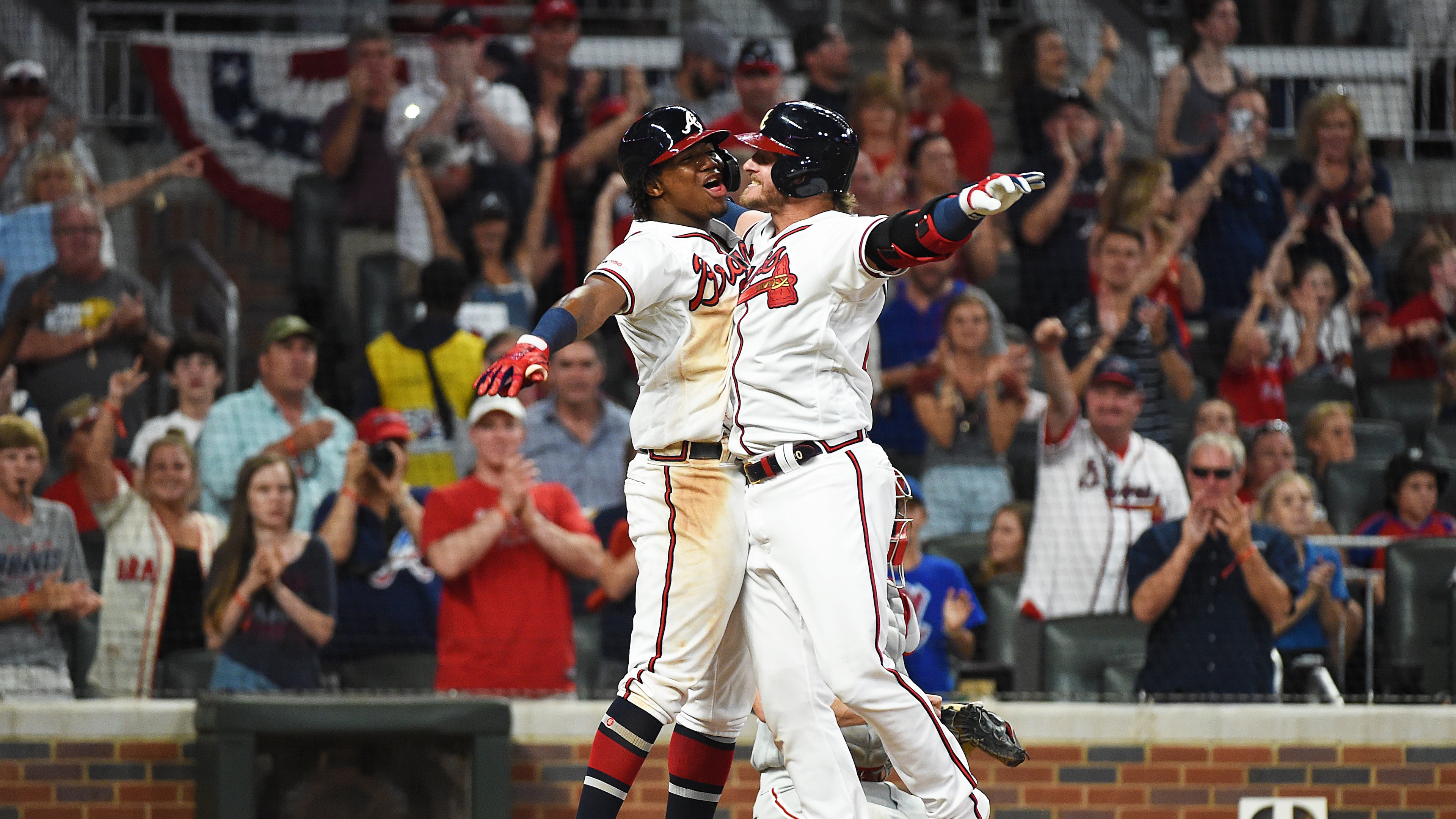 A large crowd celebrates along with Ronald Acuna and Josh Donaldson after Donaldson’s three-run homer against the Phillies on Saturday night.