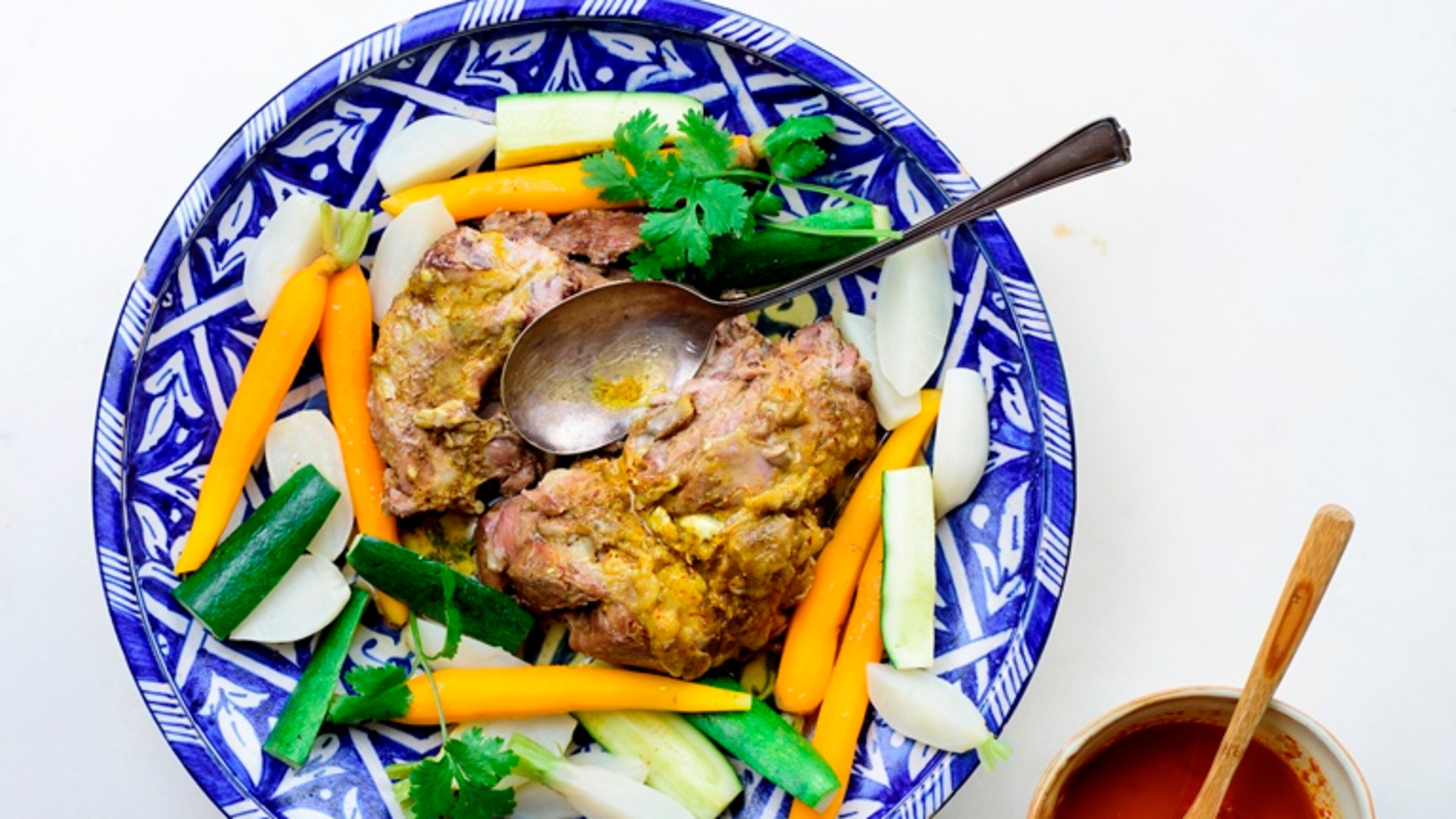 Moroccan steamed lamb shoulder, with saffron butter and red pepper oil, in New York, Sept. 15, 2015. Steaming a lamb shoulder -- a cut that has fat marbled throughout -- with briskly boiling water for two and a half to three hours results in falling-of-the-bone succulence.