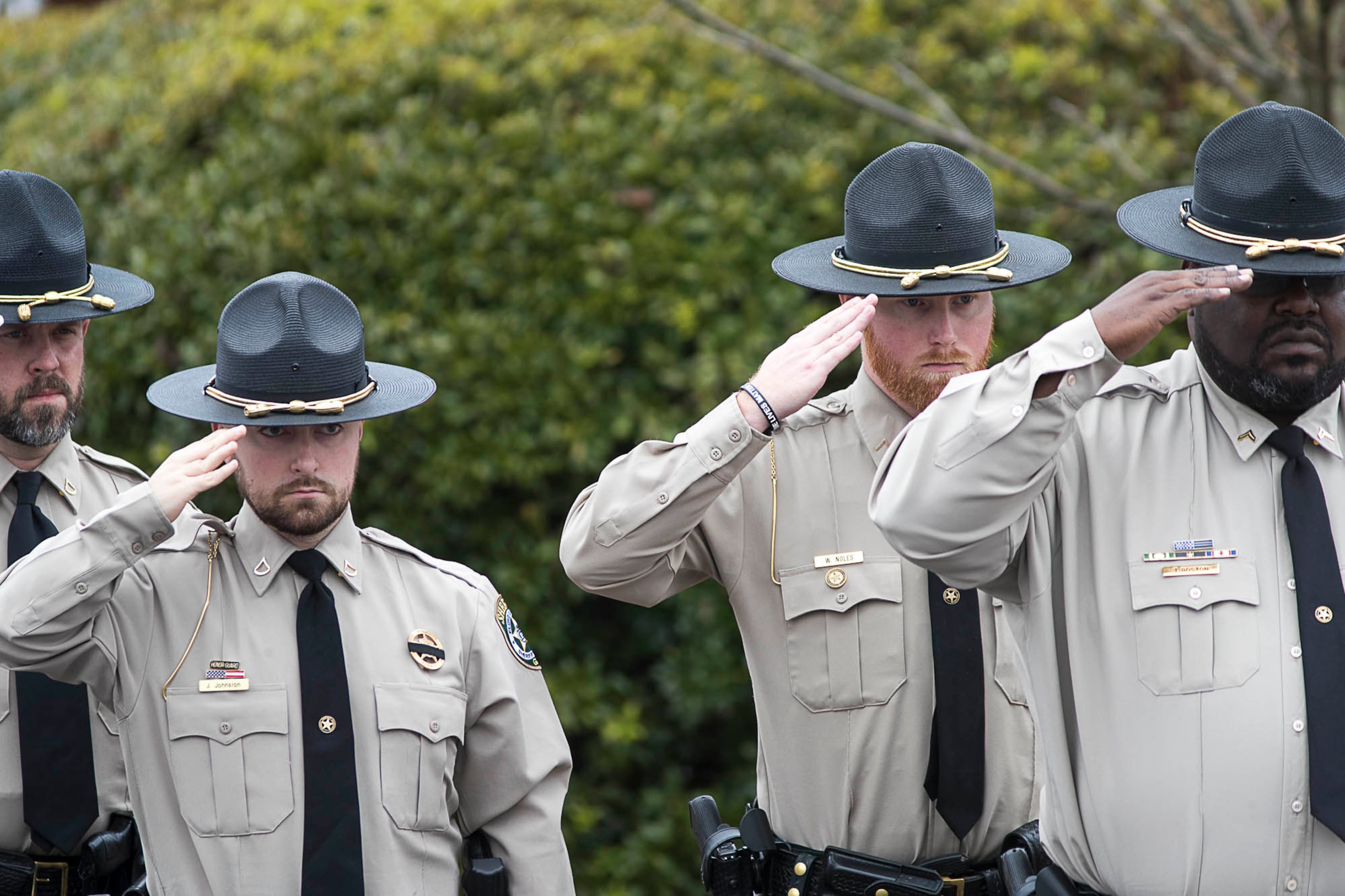 01/03/2019 -- McDonough, Georgia -- Floyd County Sheriffs Officers salute the casket of slain Henry County Police Officer Michael Smith as his body is carried into Glen Haven Baptist Church in McDonough, Thursday, January 3, 2019. Henry County police Officer Michael Smith Smith, 33, was shot Dec. 6 while responding to a report of an irate man at a McDonough-area dental office. According to investigators, a single shot struck and killed that man and critically injured Smith. He survived the initial shooting and was recovering. But three weeks later, Smith died from his injuries. (ALYSSA POINTER/ALYSSA.POINTER@AJC.COM)