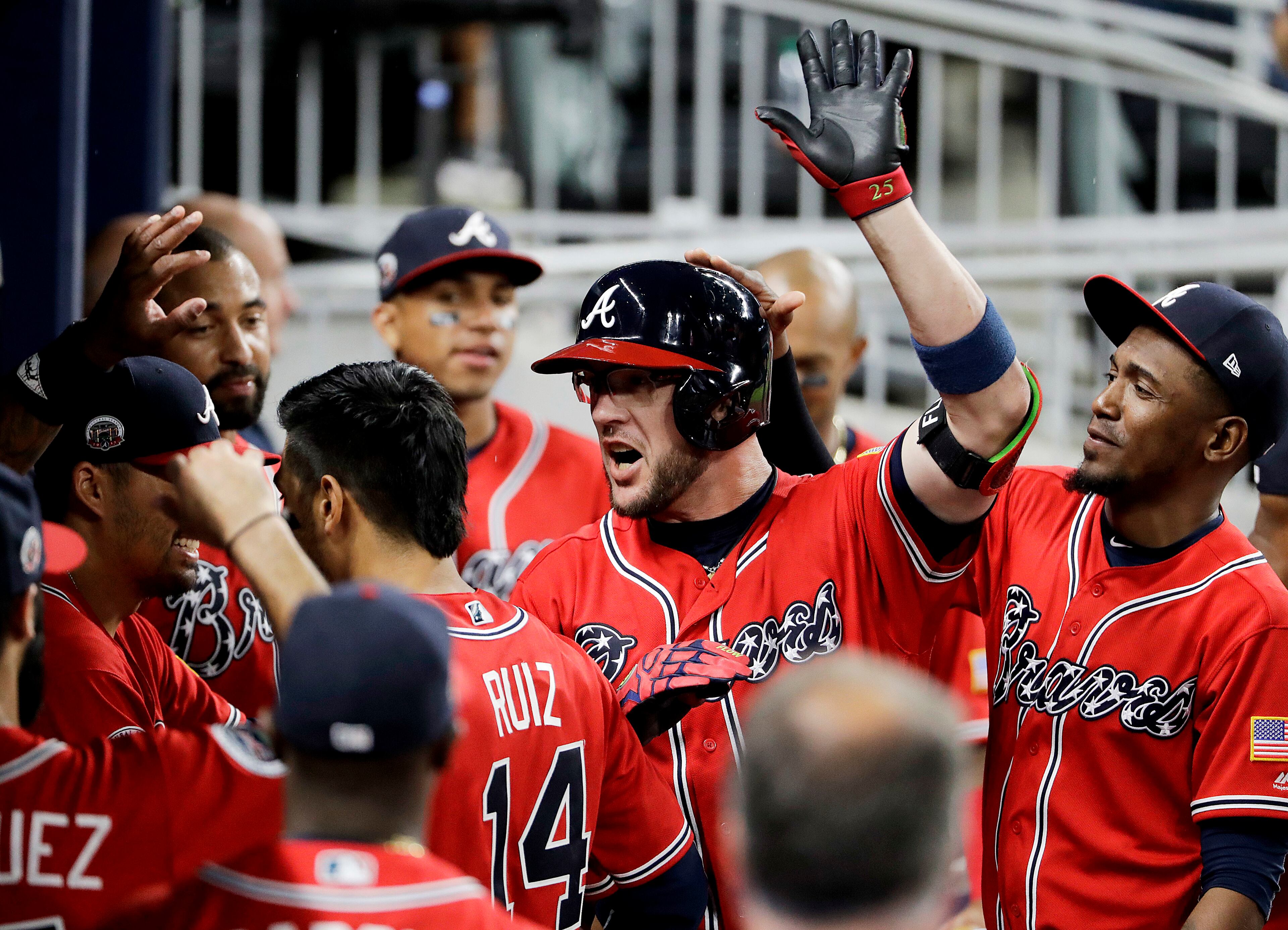 Atlanta Braves' Tyler Flowers, center, high-fives teammates after hitting a home run in the eighth inning of a baseball game against the Washington Nationals in Atlanta, Saturday, May 20, 2017. (AP Photo/David Goldman)