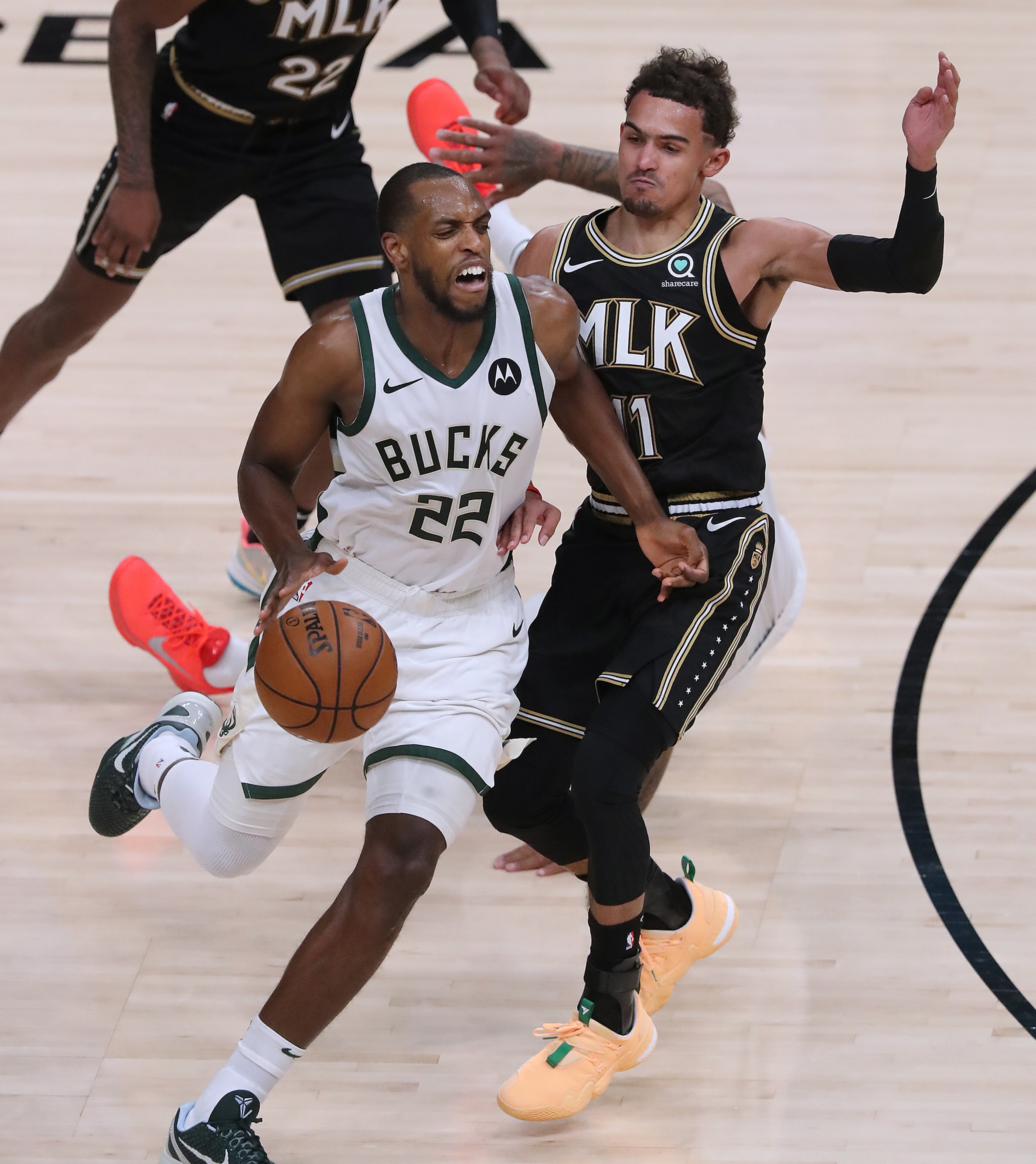 070321 Atlanta: Milwaukee Bucks forward Khris Middleton drives past Atlanta Hawks guard Trae Young during the third quarter in game 6 of the NBA Eastern Conference Finals on Saturday, July 3, 2021, in Atlanta. “Curtis Compton / Curtis.Compton@ajc.com”