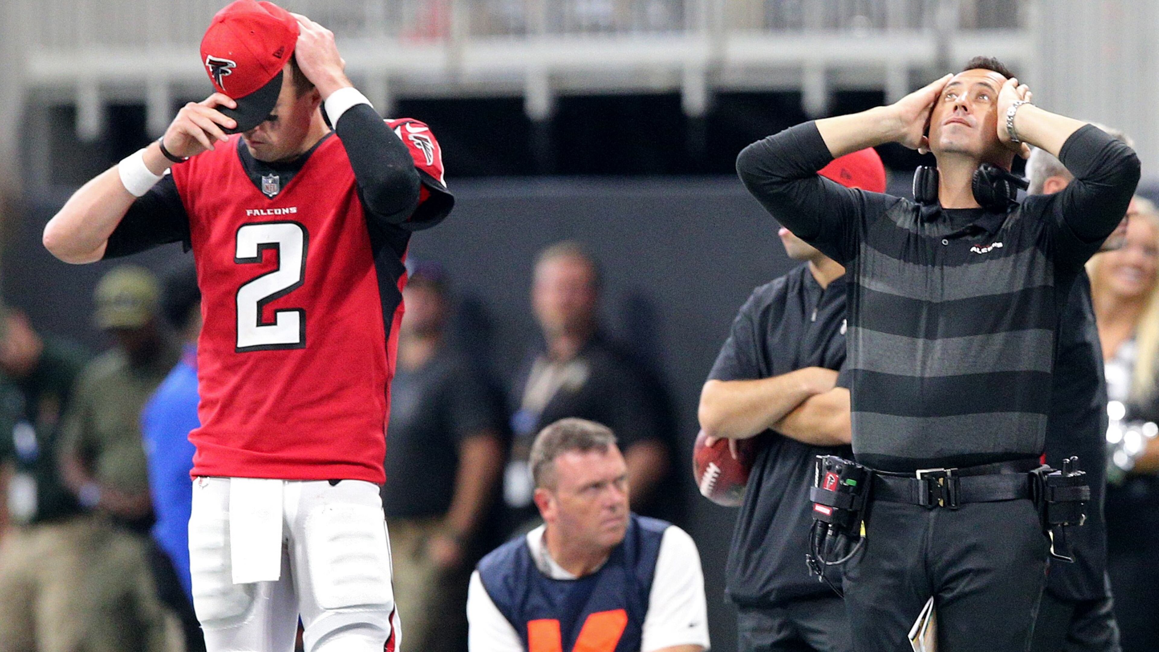 Atlanta Falcons quarterback Matt Ryan and offensive coordinator Steve Sarkisian react on the sidelines as the New Orleans Saints win on a Drew Brees touchdown in overtime on Sunday, Sept 23, 2018, in Atlanta.