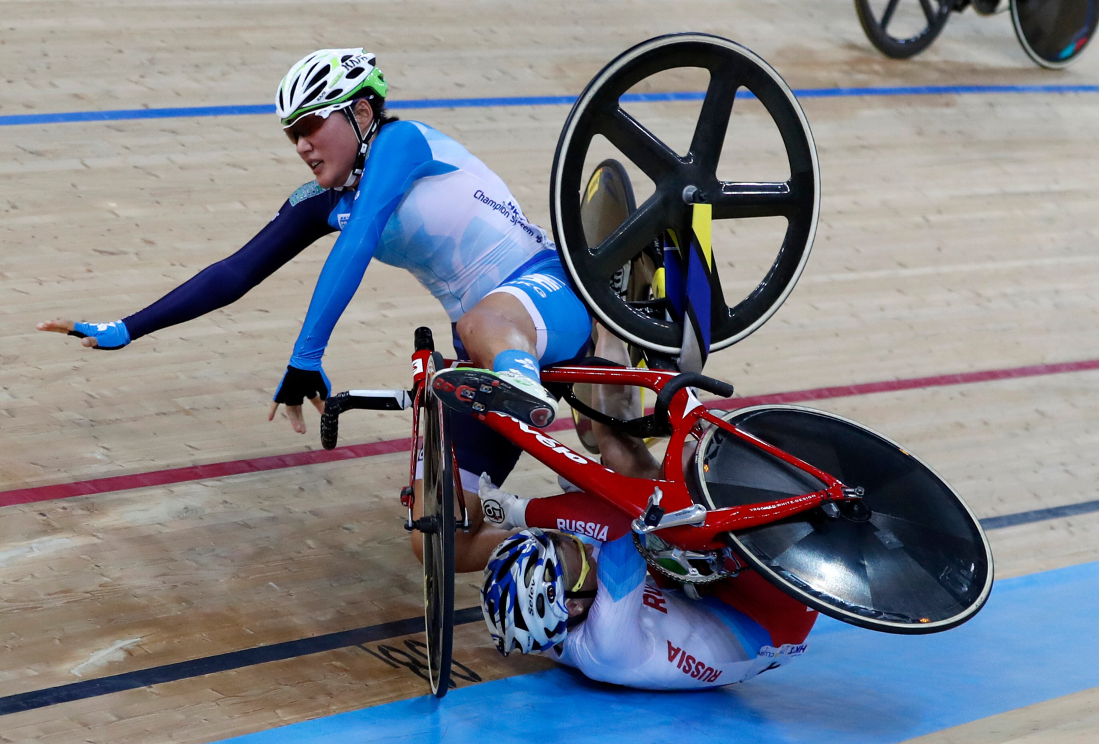 Hong Kong's Pang Yao, left, and Russia's Mariia Averina collide and crash during the women's madison at the World Track Cycling championships in Hong Kong, Saturday, April 15, 2017. (AP Photo/Kin Cheung)