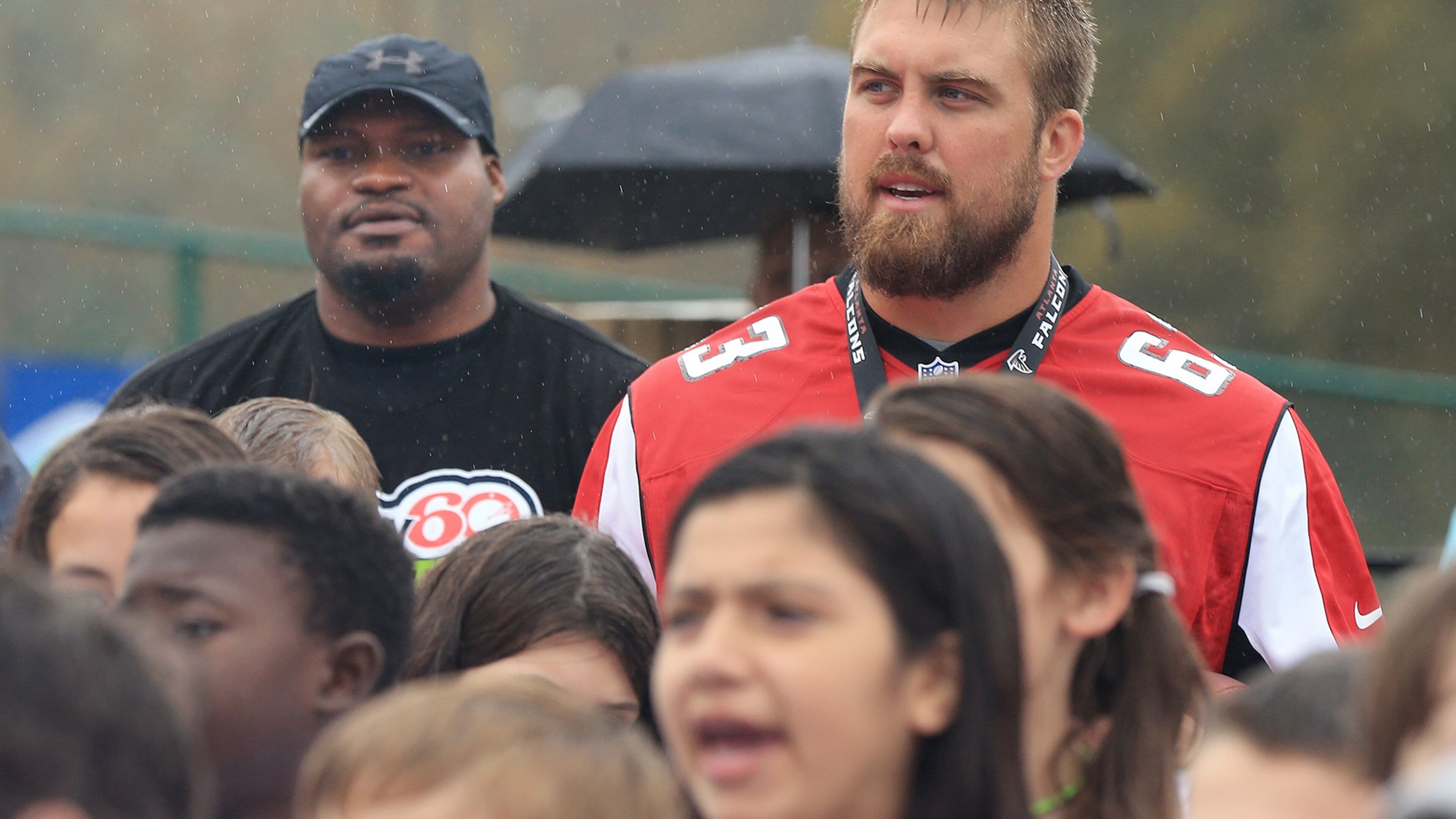 110315 GAINESVILLE: — Former Falcons defensive tackle Rod Coleman and Falcons offensive lineman Ben Garland tower over participants during the NFL PLAY 60 Character Camp at Gainesville High School on Tuesday, Nov. 3, 2015 in Gainesville. NFL PLAY 60 is the league’s campaign to encourage kids to be active for 60 minutes a day in order to help reverse the trend of childhood obesity. Curtis Compton / ccompton@ajc.com