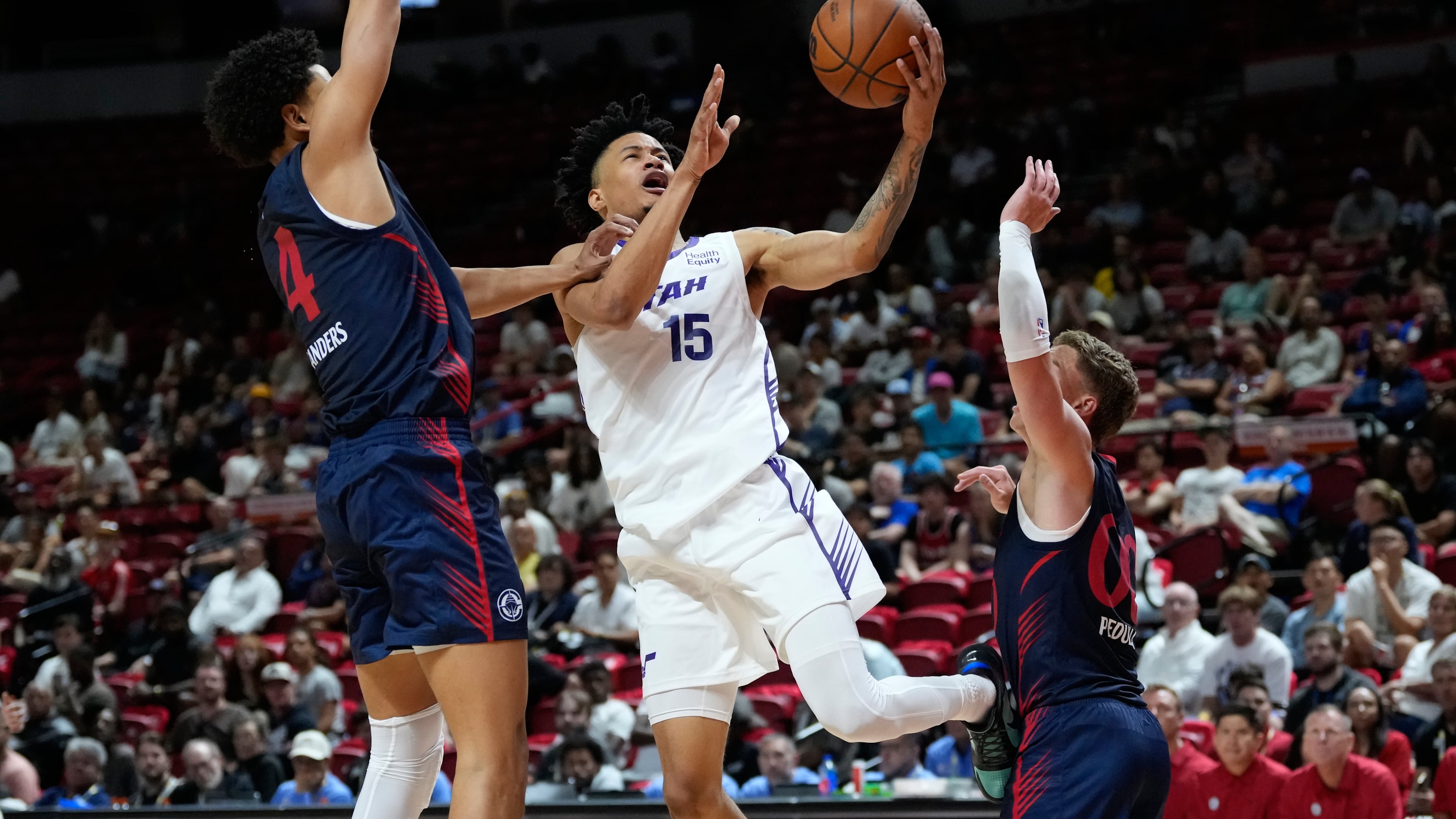 Utah Jazz's Trey Alexander shoots against LA Clippers' Kobe Sanders, left, and LA Clippers' Sean Pedulla during the second half of an NBA Summer League basketball game Sunday, July 12, 2026, in Las Vegas. (AP Photo/John Locher)