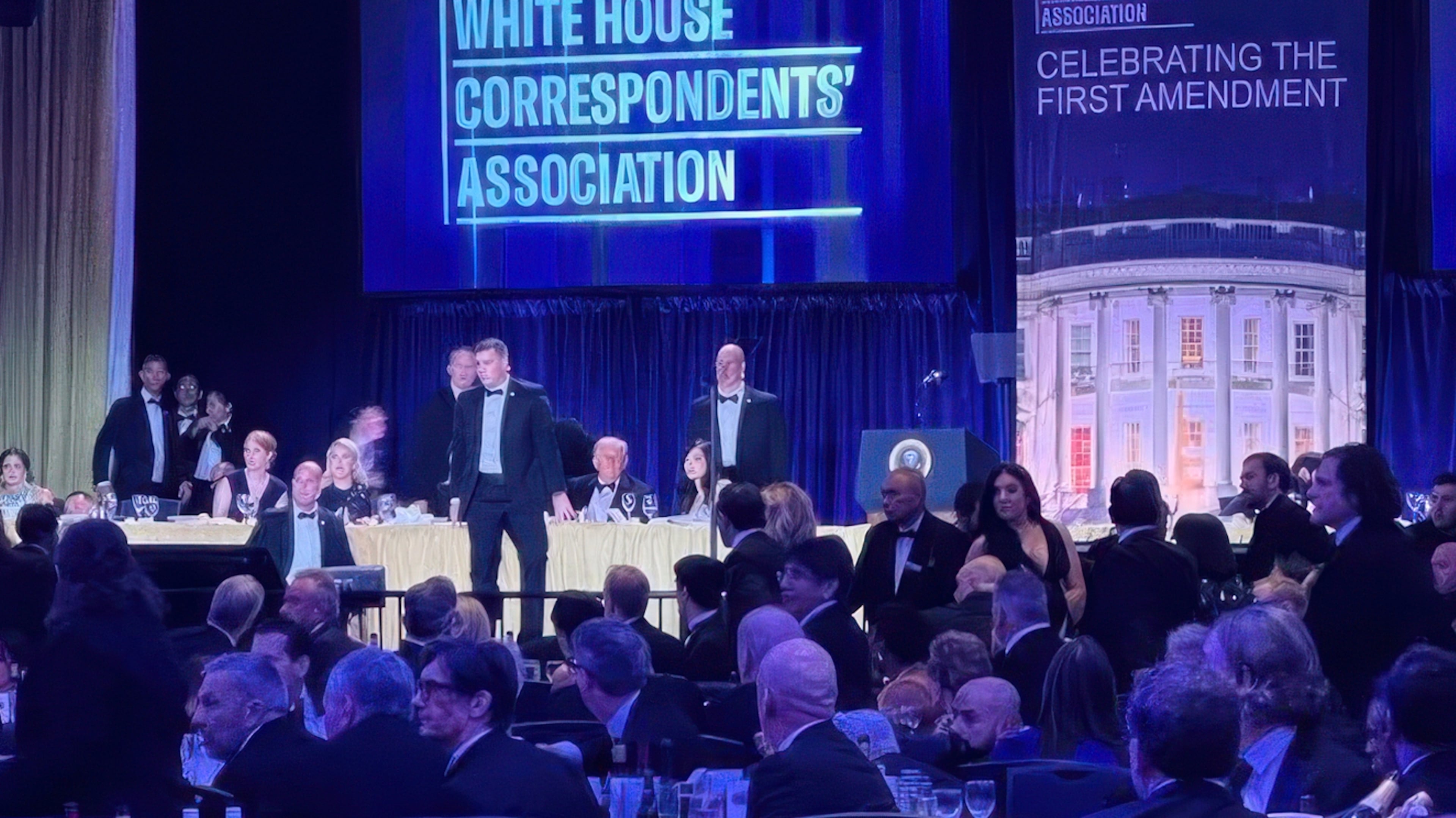 U.S. Secret Service agents surround President Donald Trump as he is taken from the stage after a shooting incident outside the ballroom during the White House Correspondents Dinner, Saturday, April 25, 2026, in Washington. (Alex Brandon/AP)