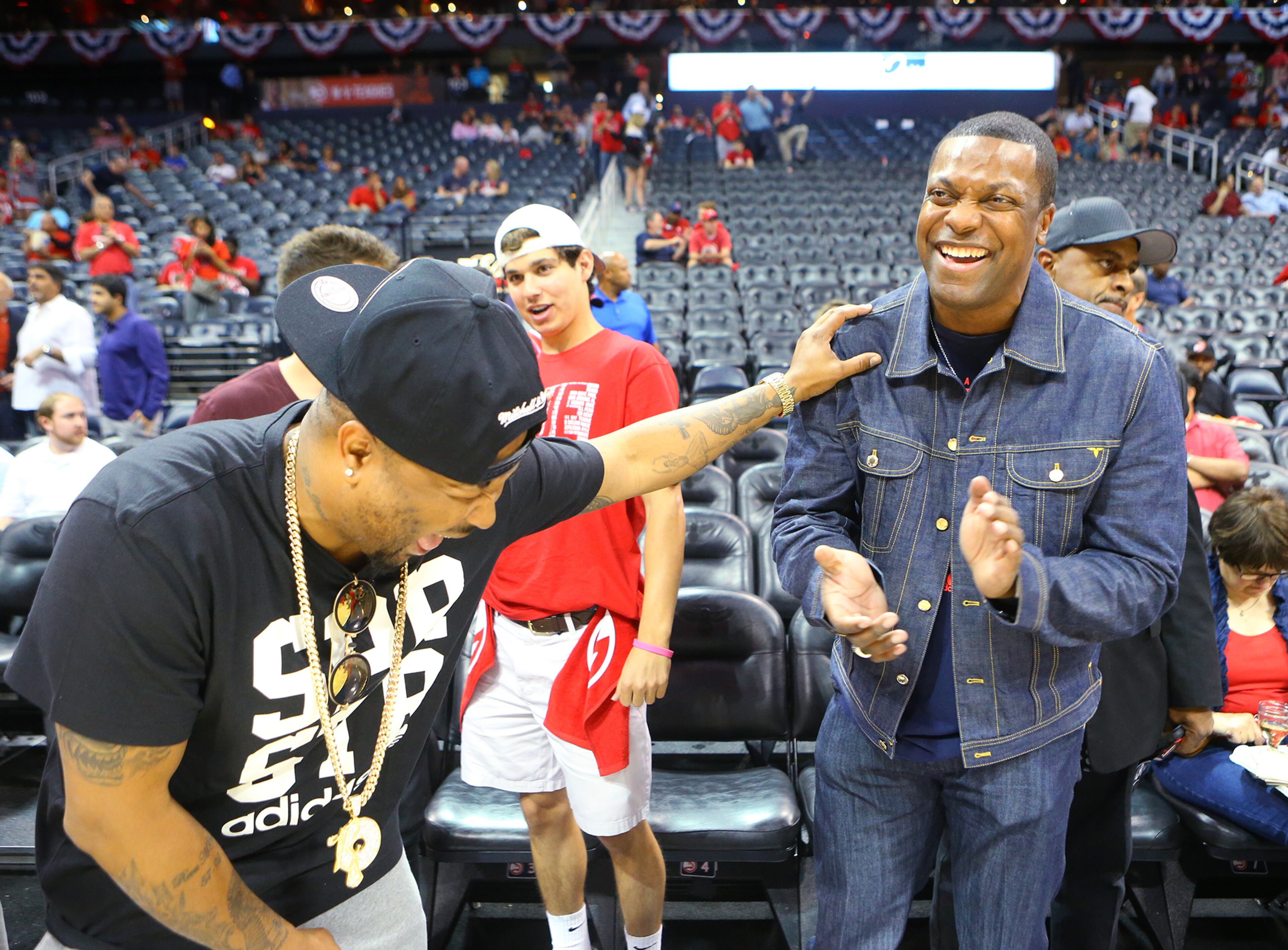 The Dream (left) and Chris Tucker share a laugh court side as the Hawks prepare to play the Wizards in their Eastern Conference Semifinals game 5 on Tuesday, May 13, 2015, in Atlanta. Curtis Compton / ccompton@ajc.com