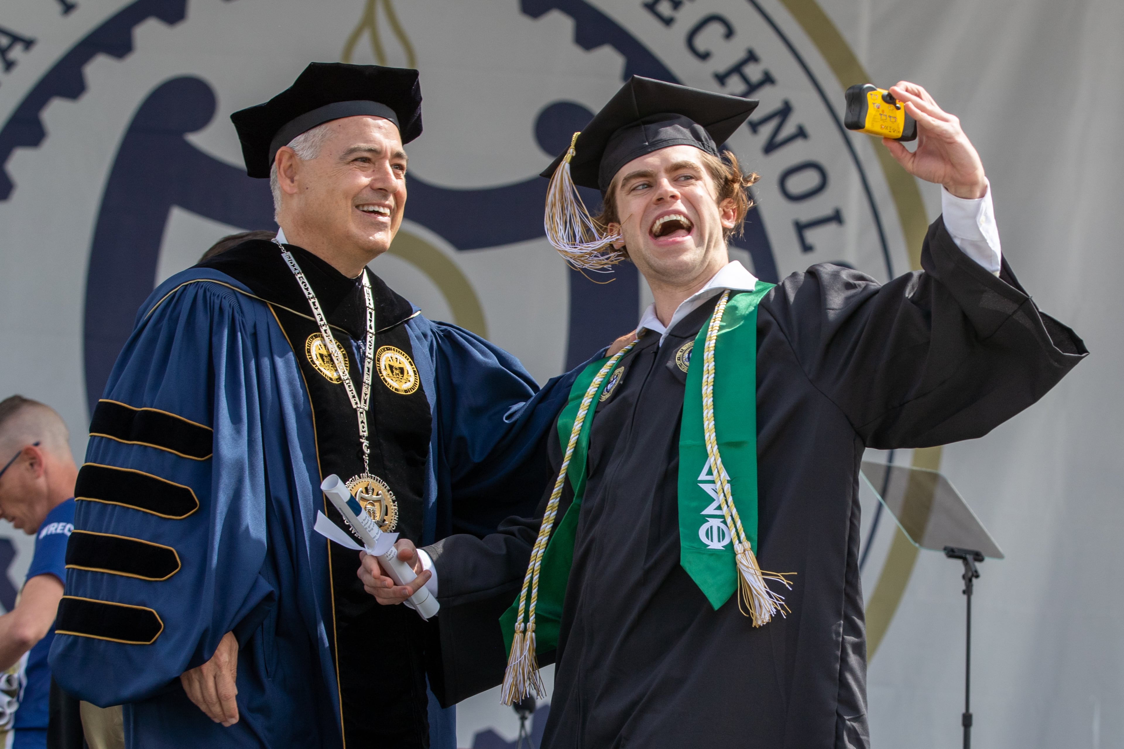 William Willis takes a photograph with Georgia Tech President Ángel Cabrera after receiving his diploma during the Georgia Institute of Technology's afternoon Commencement Ceremony at Bobby Dodd Stadium on Saturday, May 7, 2022. (Steve Schaefer / steve.schaefer@ajc.com)
