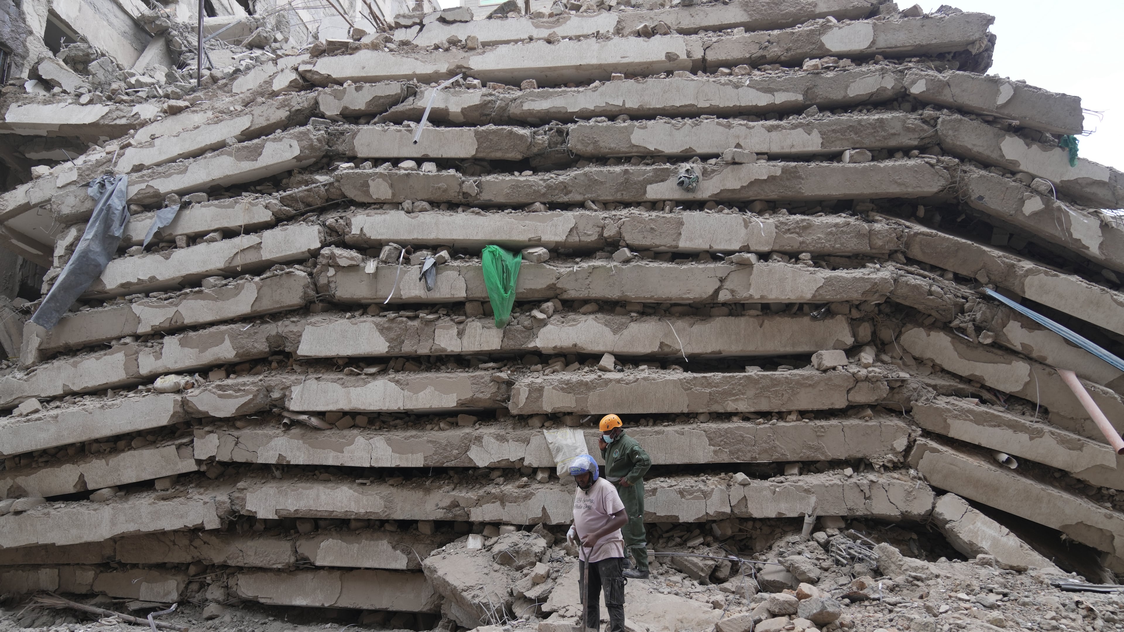 Security forces and civil defense work after a multi-story building collapsed in Nairobi, Kenya, Friday, Oct. 23, 2026. (AP Photo/Brian Inganga)