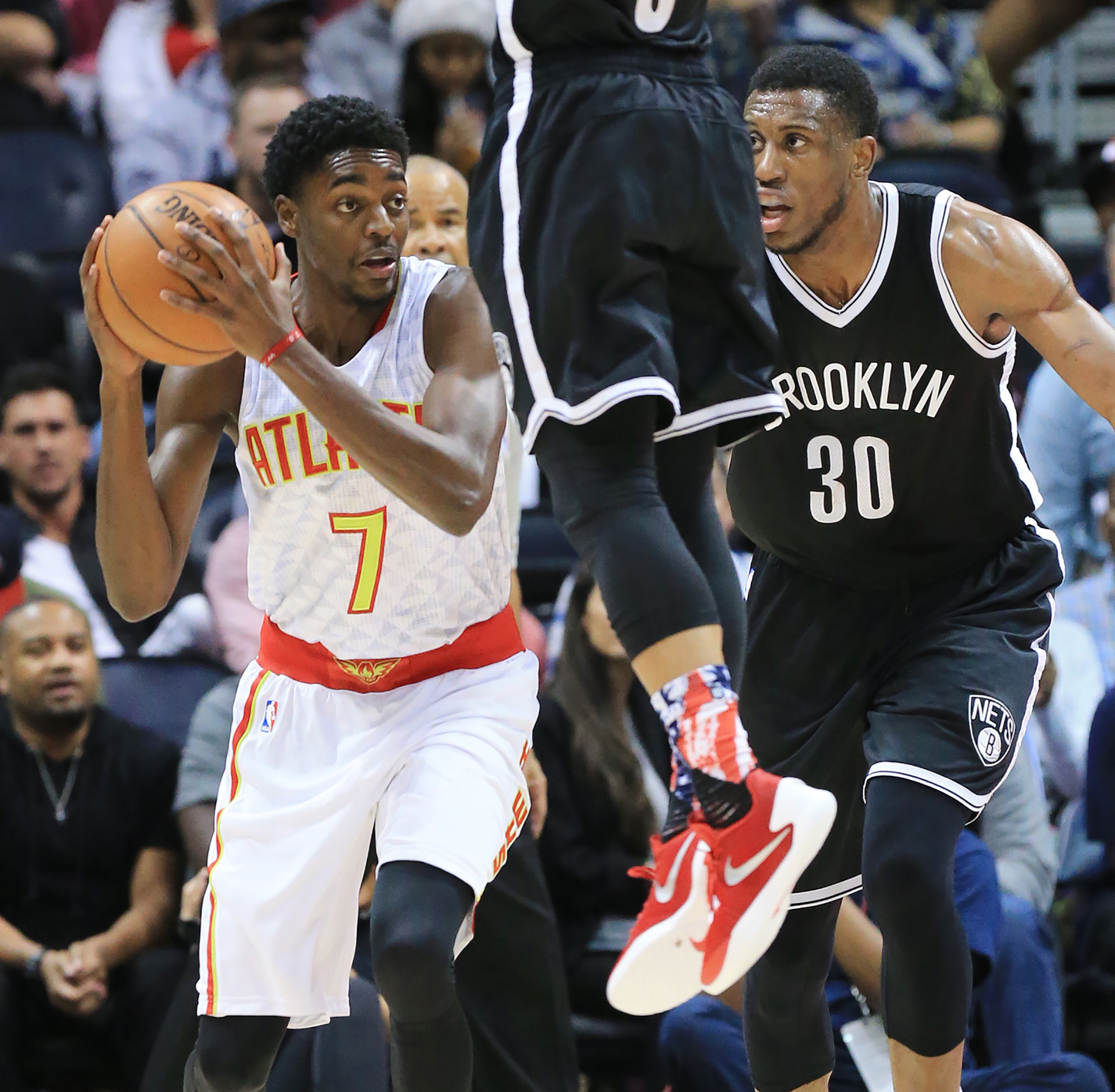 110415 ATLANTA: -- Hawks Justin Holiday wins the rebound battle taking the ball away from the Nets Thaddeus Young during the first period in a basketball game on Wednesday, Nov. 4, 2015 in Atlanta. Curtis Compton / ccompton@ajc.com