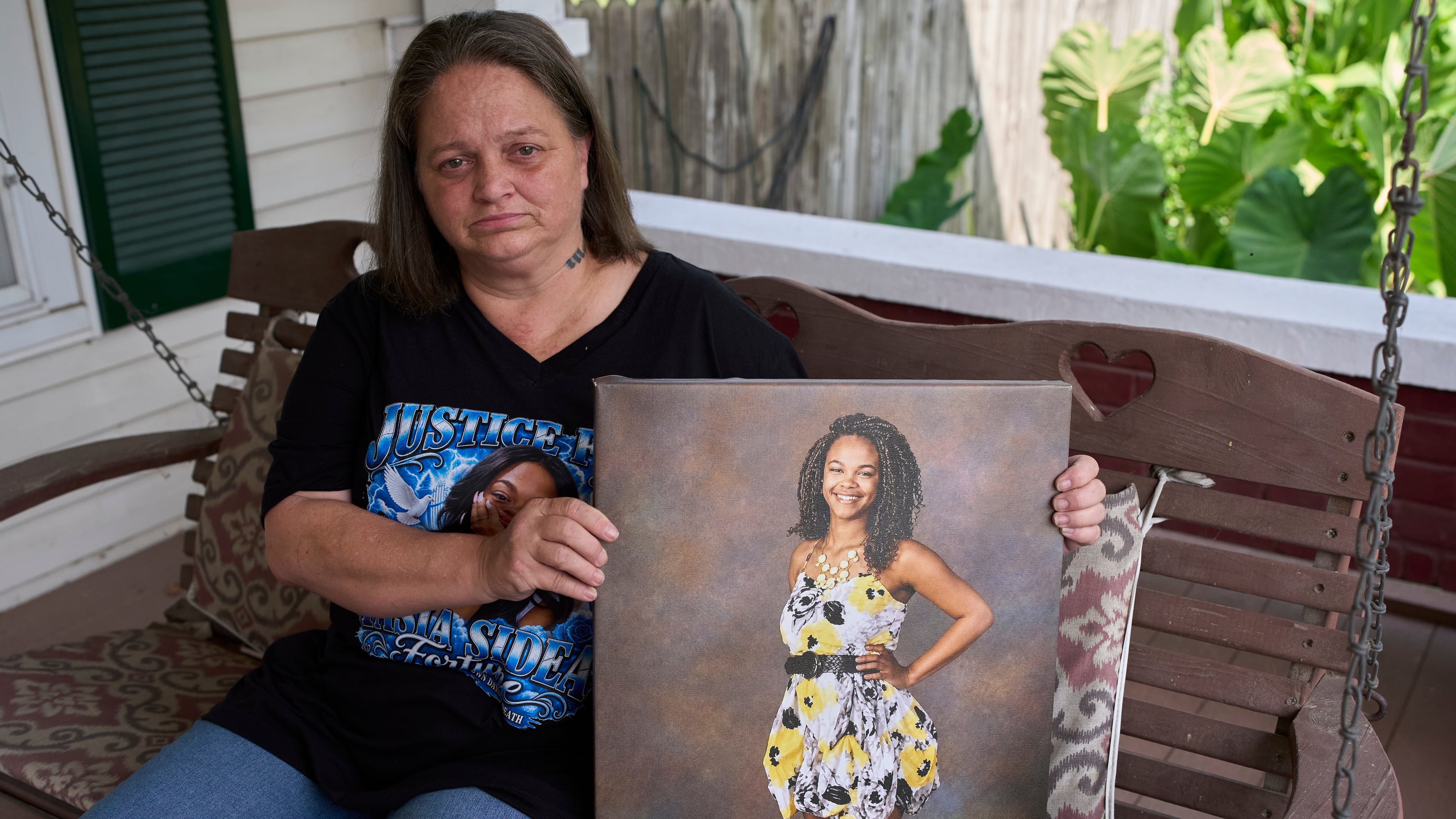 Christy Spivey poses with a portrait of her late daughter Tasia Fortune, Tuesday, Sept. 8, 2026, in Marion, Ky. (AP Photo/George Walker IV)
