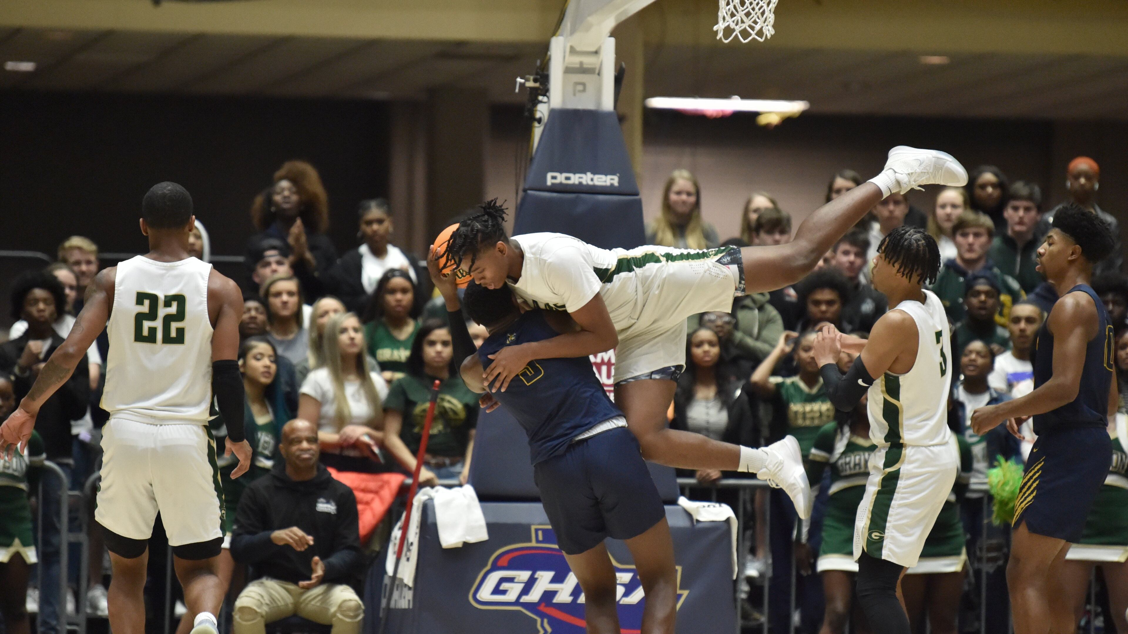 Grayson's Taje Kelly (10) falls onto Wheeler's Ja'Hiem Hudson (3) as Hudson prepares to shoot during 2020 GHSA State Basketball Class Championship game at the Macon Centreplex in Macon on Saturday, March 7, 2020. Westlake won 72-53 over Collins Hill. (Hyosub Shin / Hyosub.Shin@ajc.com)