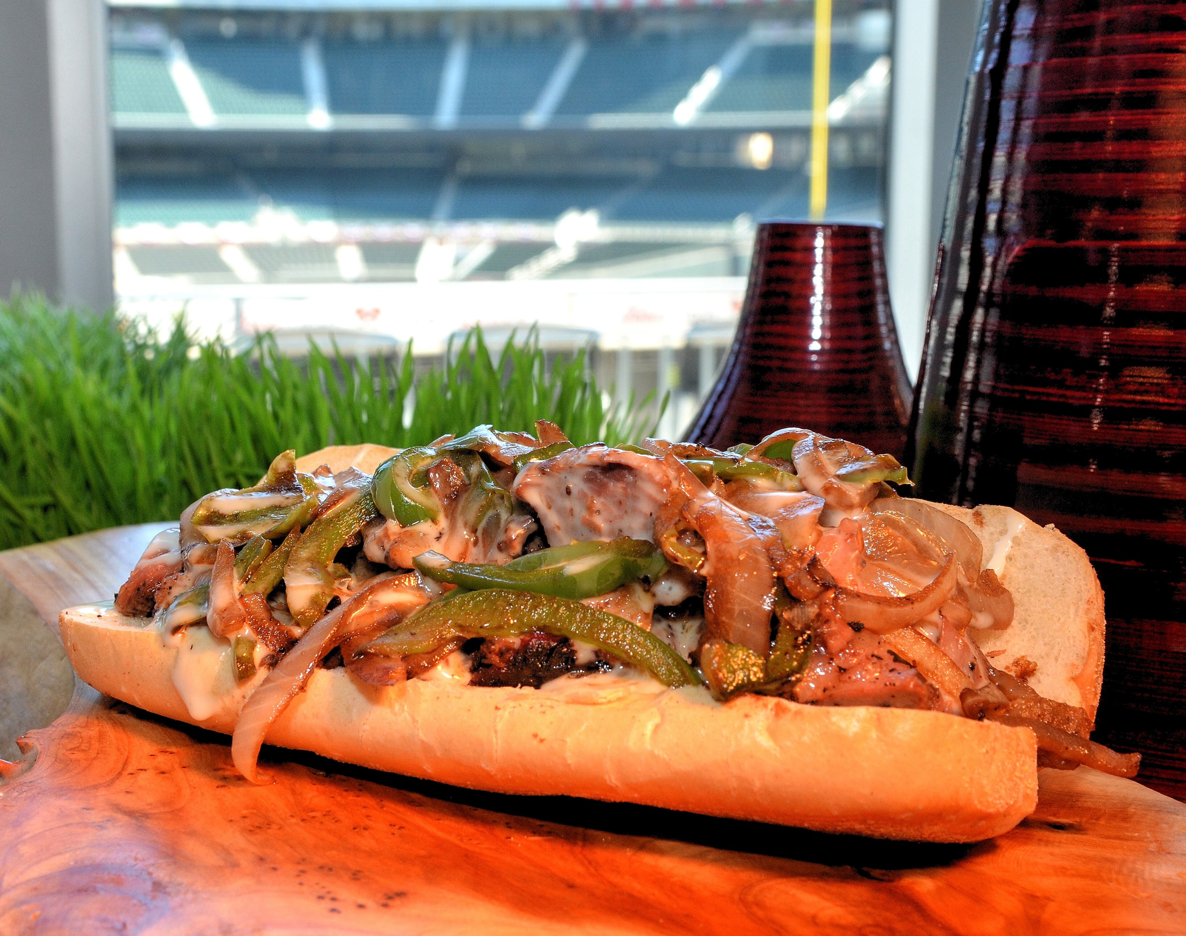 Southern Smothered Sandwich (Section 145). Ballpark Smoked Beef brisket, topped with grilled peppers and Georgia Grown sweet onions topped with creamy cheese sauce and served on a hoagie with kettle chips. $12.00