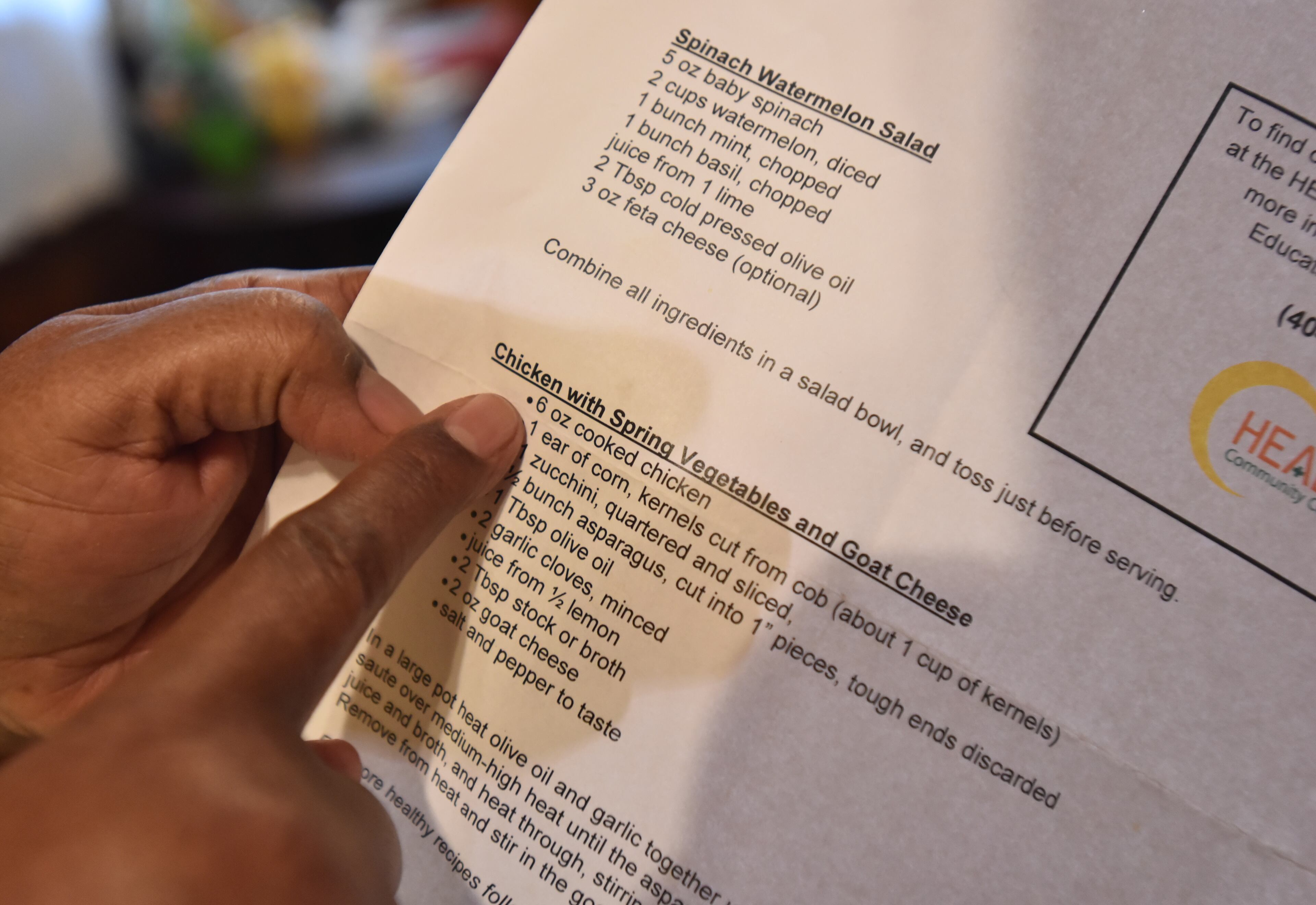 Bonita Evans holds a recipe that was provided by HEALing Community Center at her home in College Park. HYOSUB SHIN / HSHIN@AJC.COM