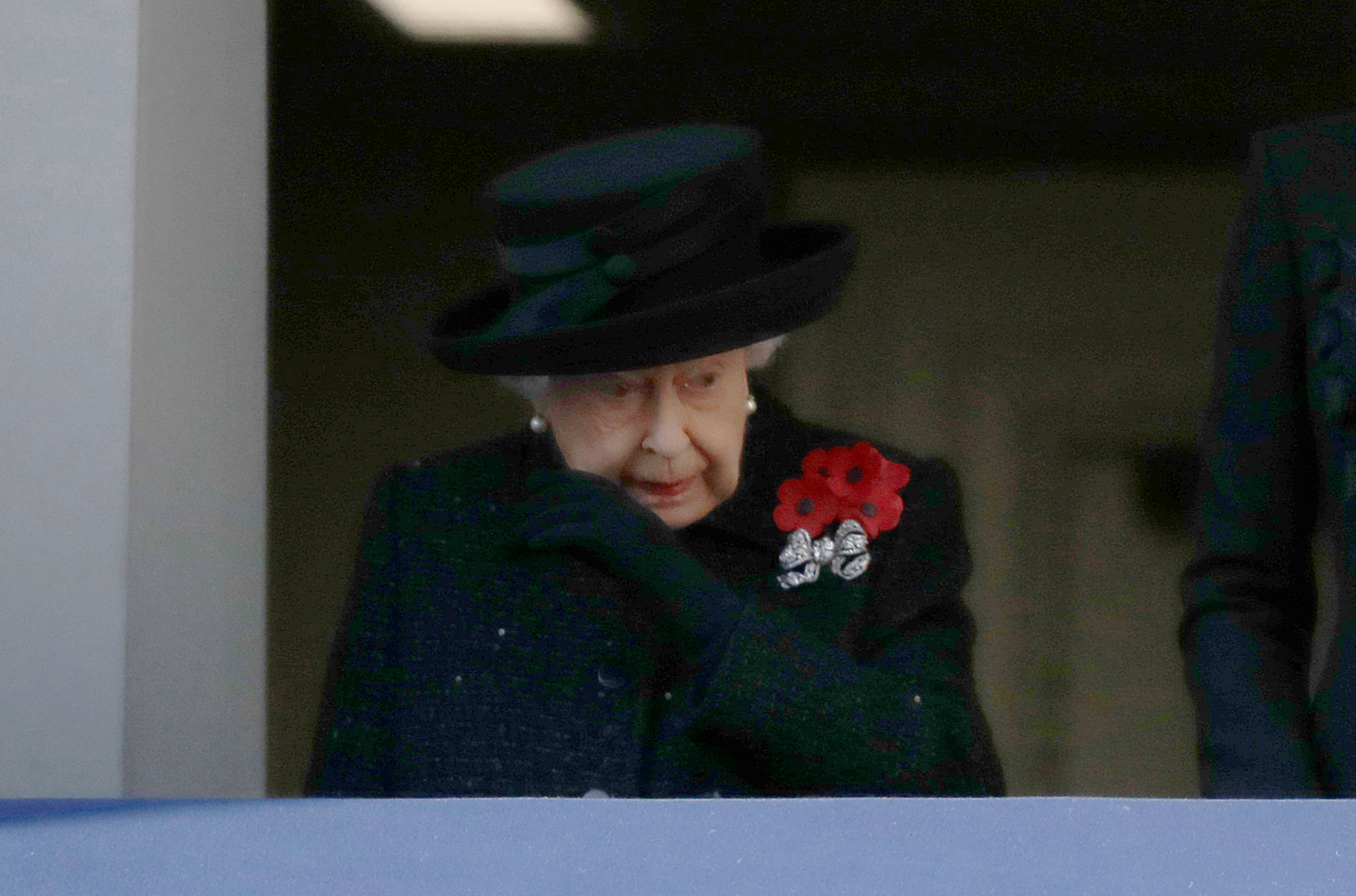 Britain's Queen Elizabeth II wipes her eye as she watches the Remembrance Sunday ceremony at the Cenotaph in Whitehall in London, Sunday, Nov. 10, 2019. Remembrance Sunday is held each year to commemorate the service men and women who fought in past military conflicts. (AP Photo/Matt Dunham)