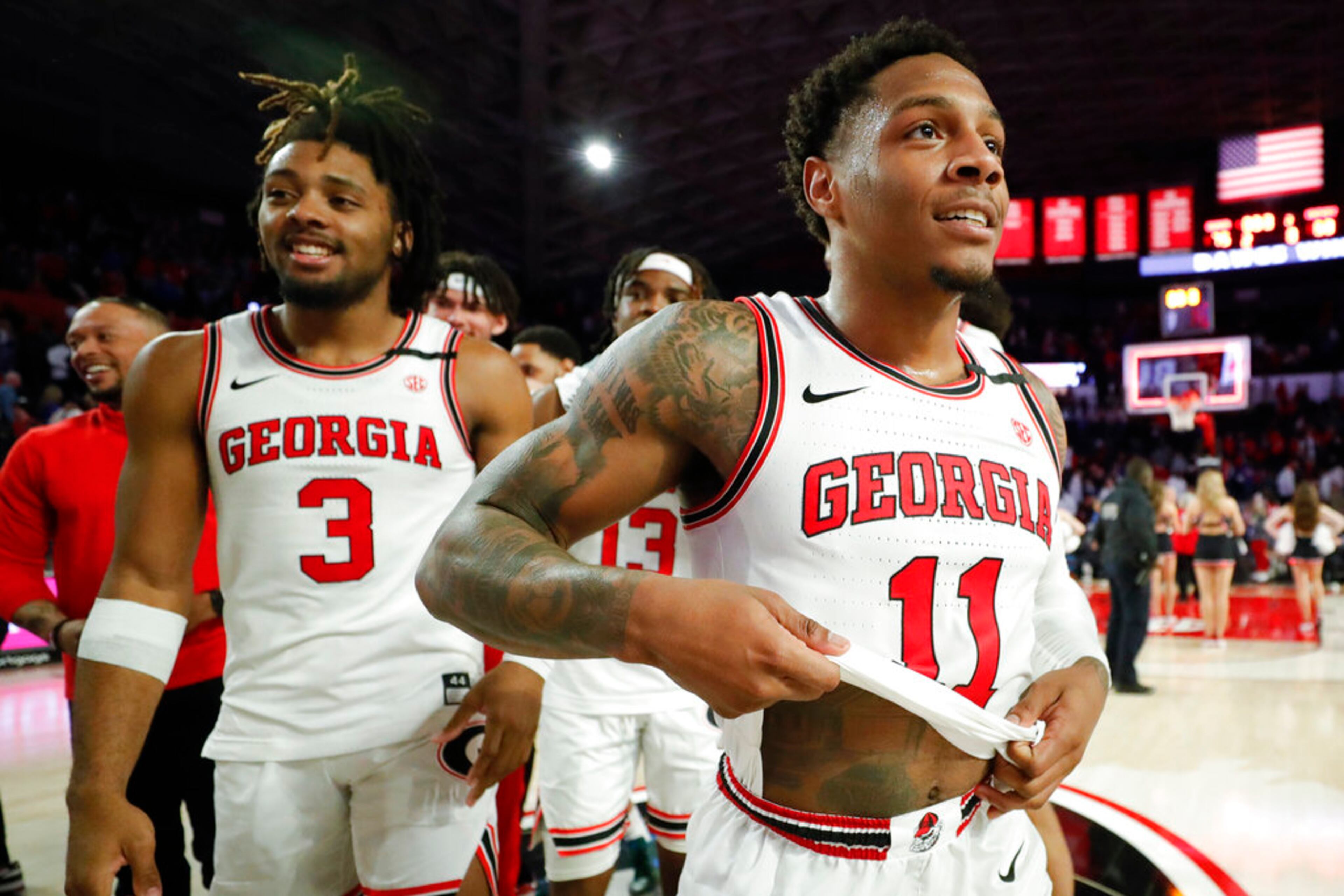 Georgia's Kario Oquendo, left, and Justin Hill, right, leave the court after an NCAA college basketball game against Kentucky, Saturday, Feb. 11, 2023, in Athens, Ga. (AP Photo/Alex Slitz)