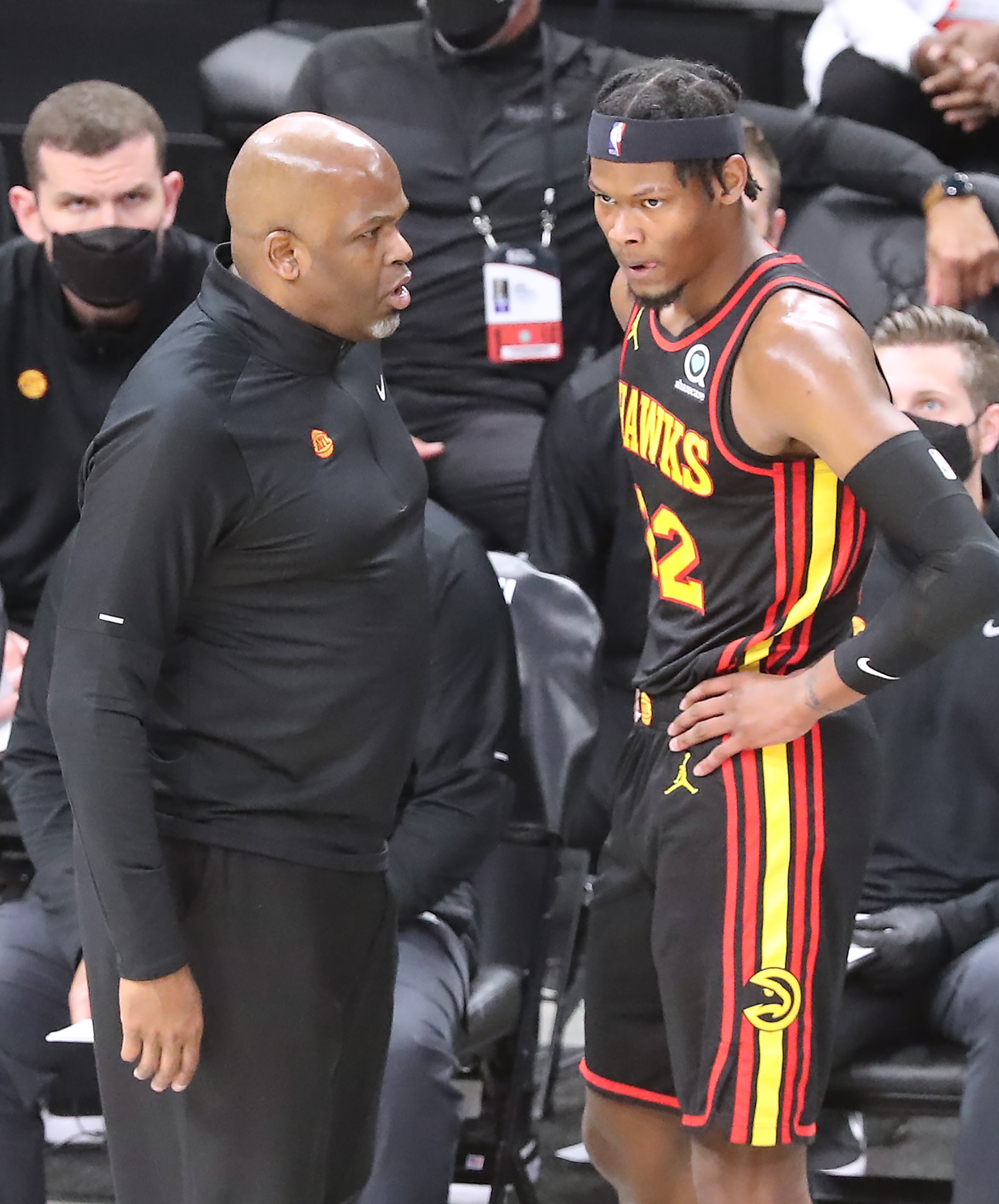 Hawks interim head coach Nate McMillan confers with forward Cam Reddish as he prepares to go back into the game. “Curtis Compton / Curtis.Compton@ajc.com”