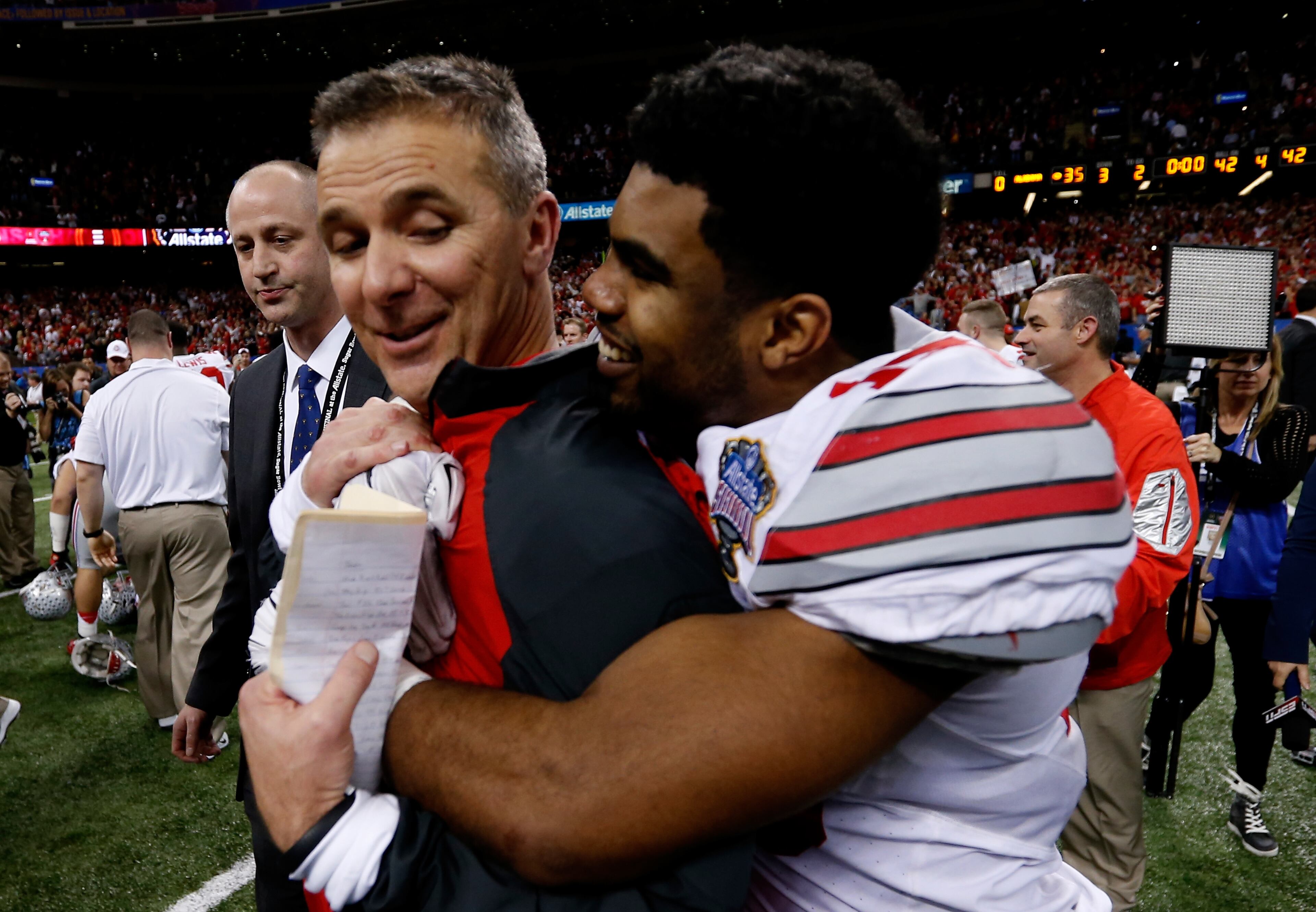 Head coach Urban Meyer of the Ohio State Buckeyes celebrates with Ezekiel Elliott #15 after defeating the Alabama Crimson Tide in the All State Sugar Bowl at the Mercedes-Benz Superdome on January 1, 2015 in New Orleans, Louisiana. The Ohio State Buckeyes defeated the Alabama Crimson Tide 42 to 35. (Photo by Sean Gardner/Getty Images)