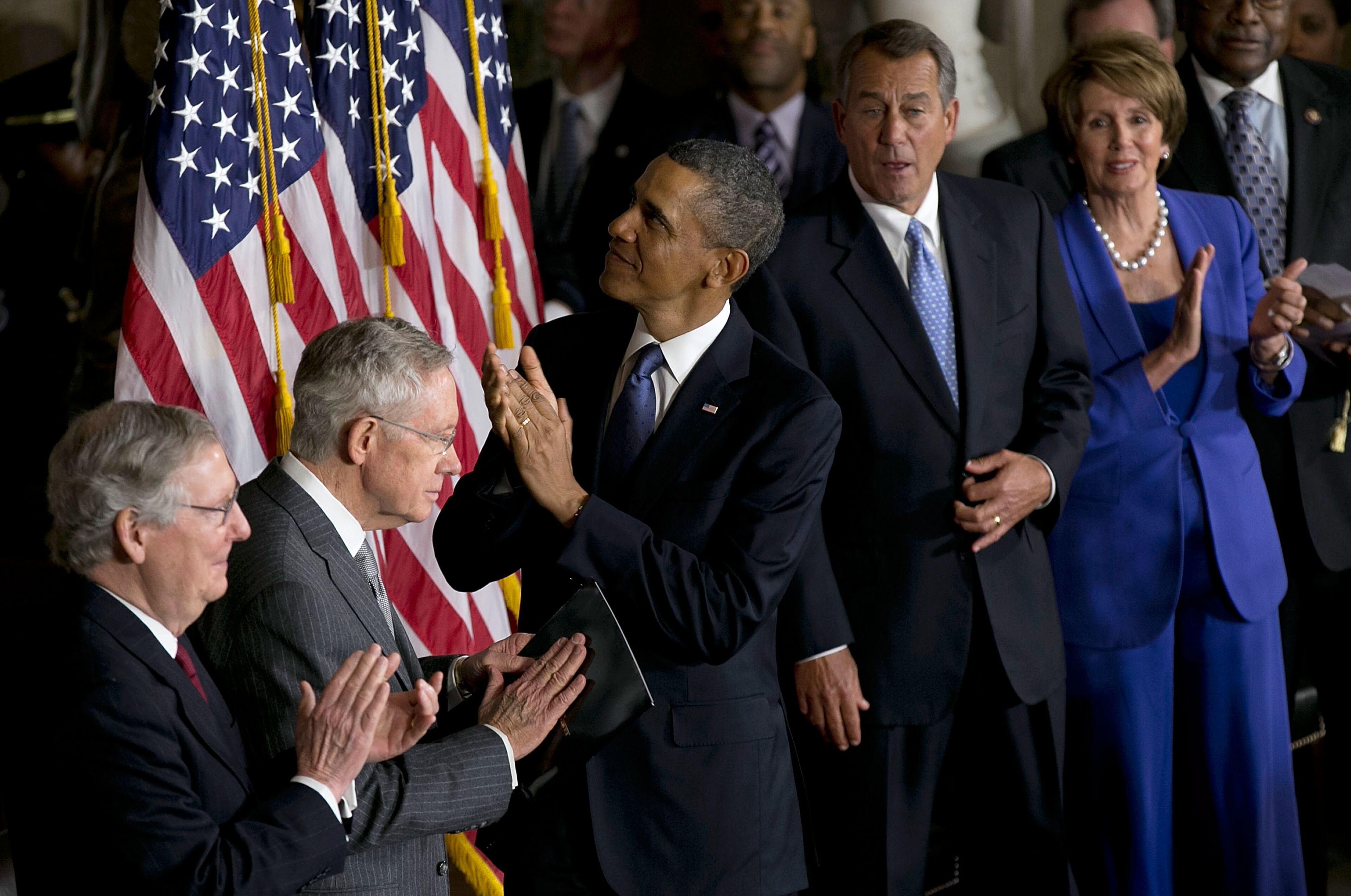 U.S. President Barack Obama and Speaker of the House John Boehner (R-OH) take part in a ceremony to unveil a statue honoring the late civil rights activist Rosa Parks in Statuary Hall of the U.S. Capitol February 27, 2013 in Washington, DC.