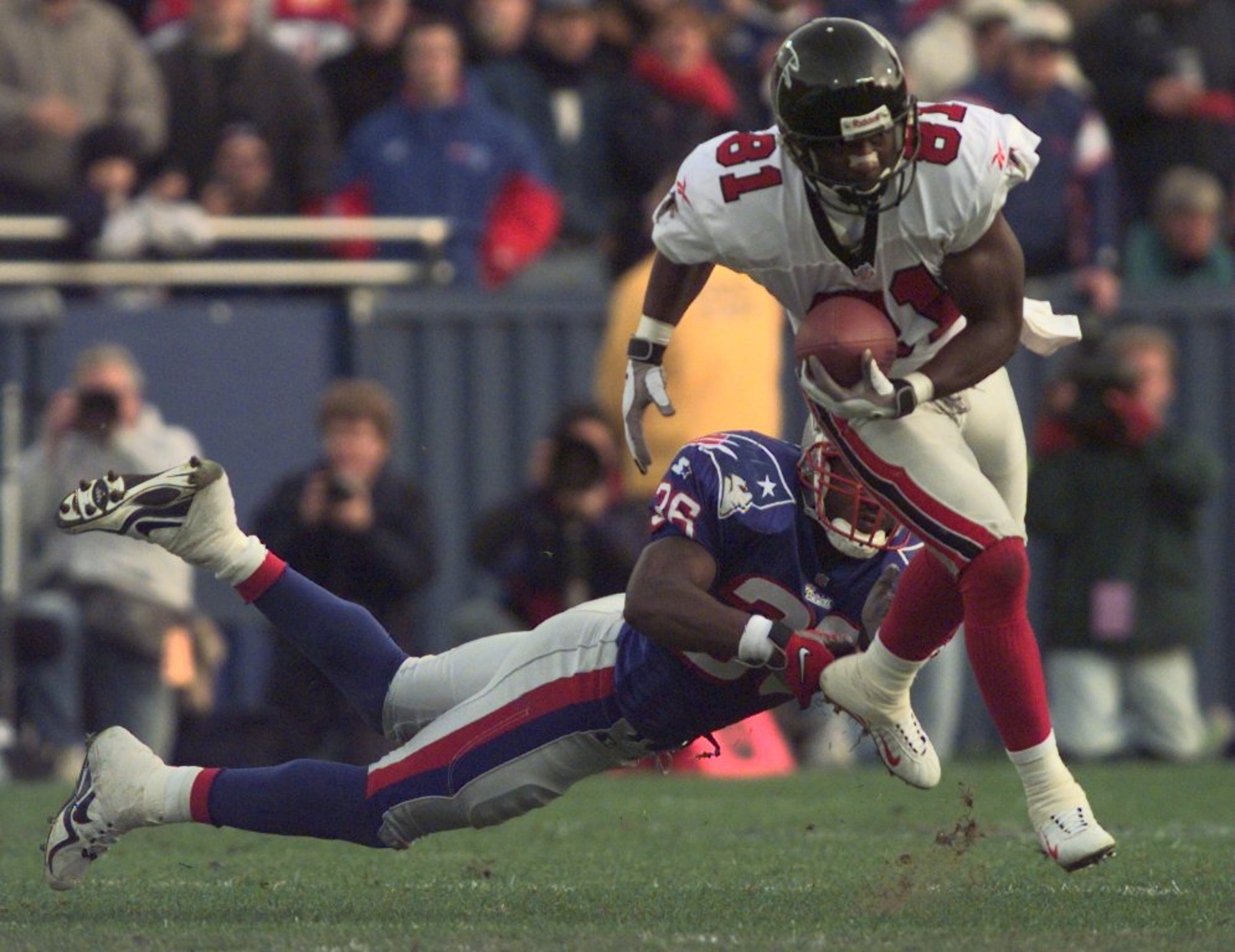 981108-FOXBORO-Atlanta Falcons Terance Mathis (cq) (WR) (81) escapes New England Patriots Lawyer Milloy (cq) (S) (36) in the second half of the game Sunday afternoon, November 8 at Foxboro Stadium. (LEVETTE BAGWELL/AJC STAFF)