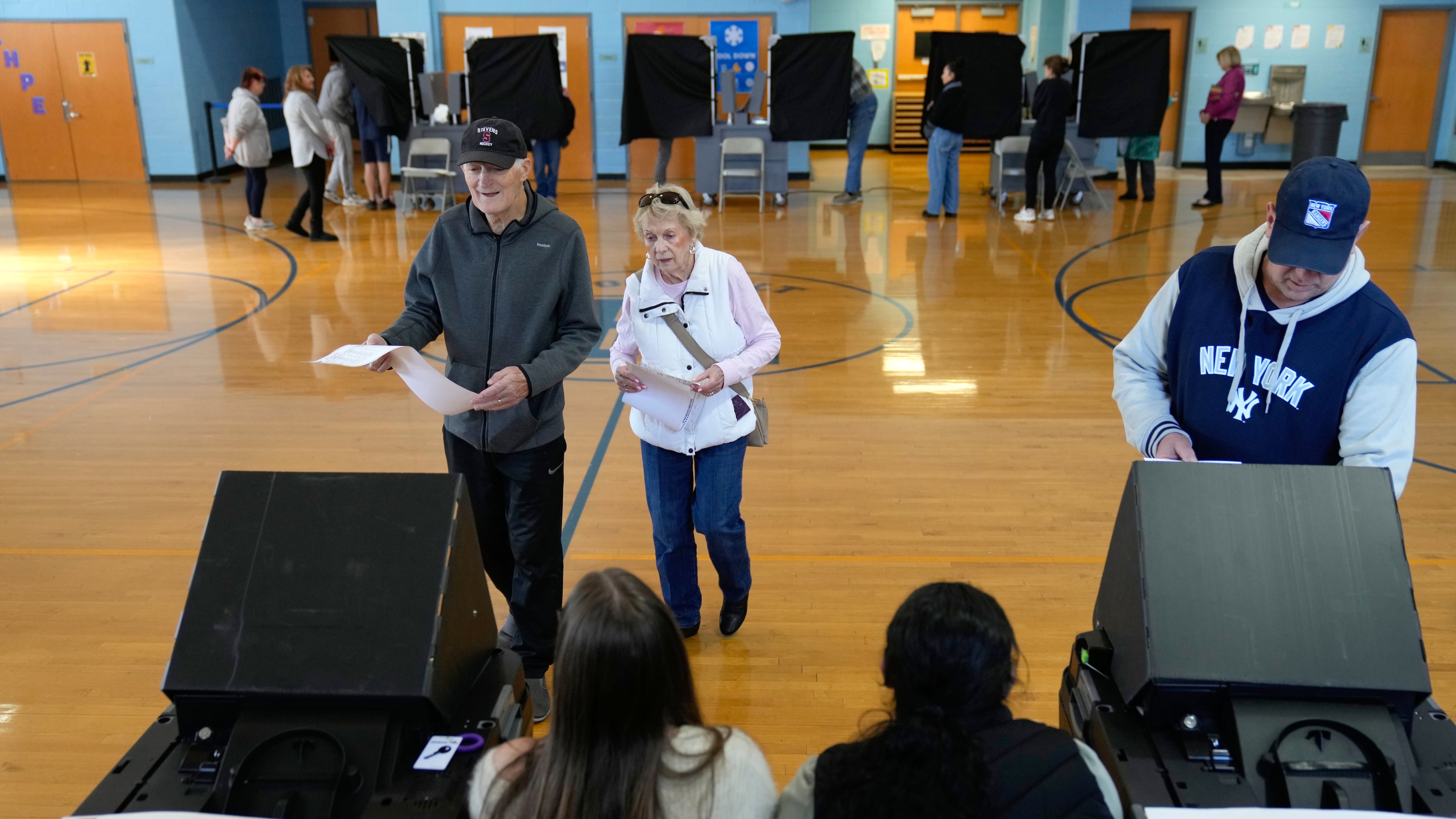 FILE - People vote at a polling site in River Edge, N.J., Nov. 4, 2025. (AP Photo/Seth Wenig, File)
