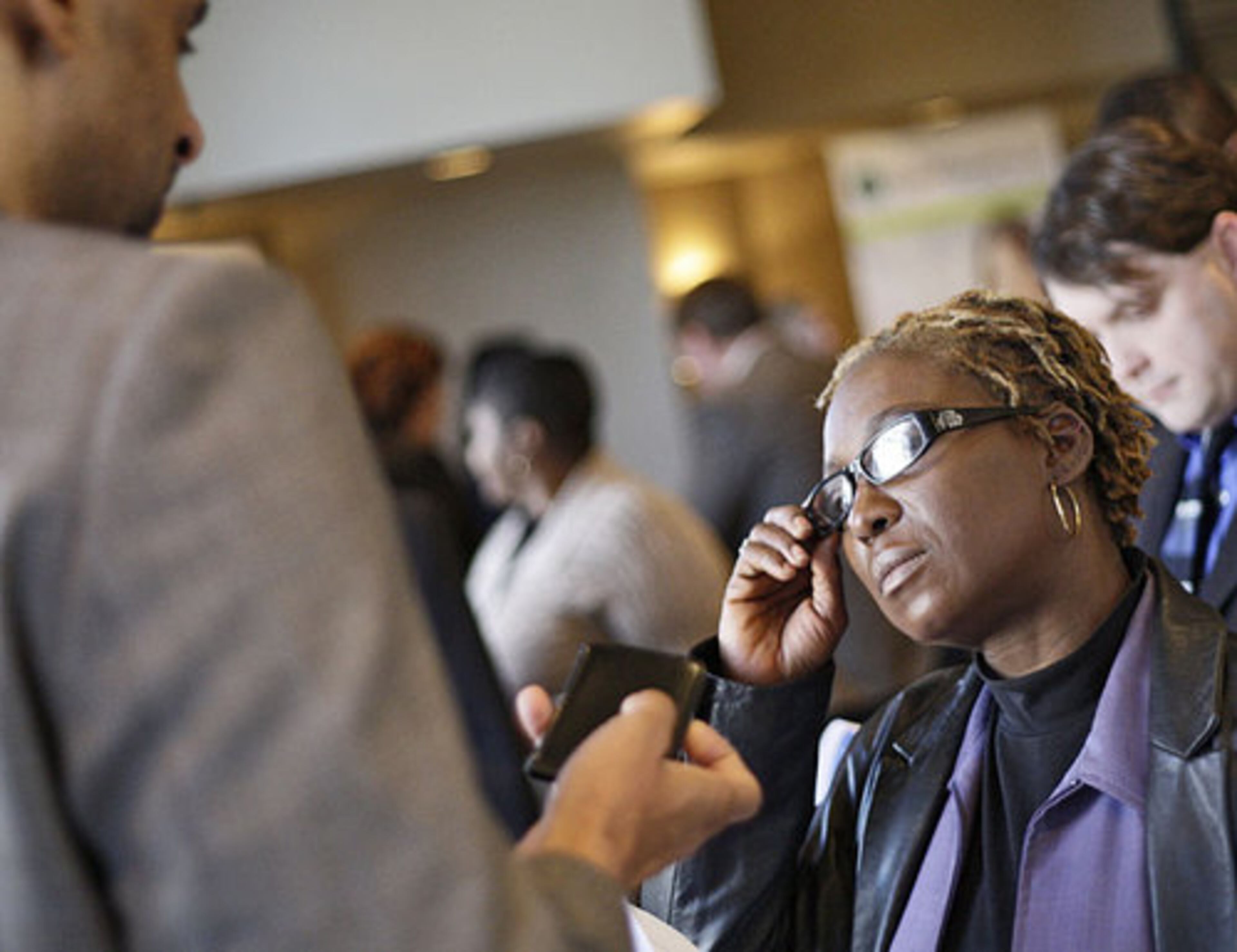 Jane Unique (right), Smyrna, talks with Stephan Butler from the Georgia Department of Labor. She has been out of work for "too long," she said. She last worked at Wachovia two years ago. The job fair at the Galleria almost didn't happen. Diversity Hiring Expos president Jim Carter was ready to cancel or reschedule the event when he had problems lining up companies for the fair, but had some last minute additions.