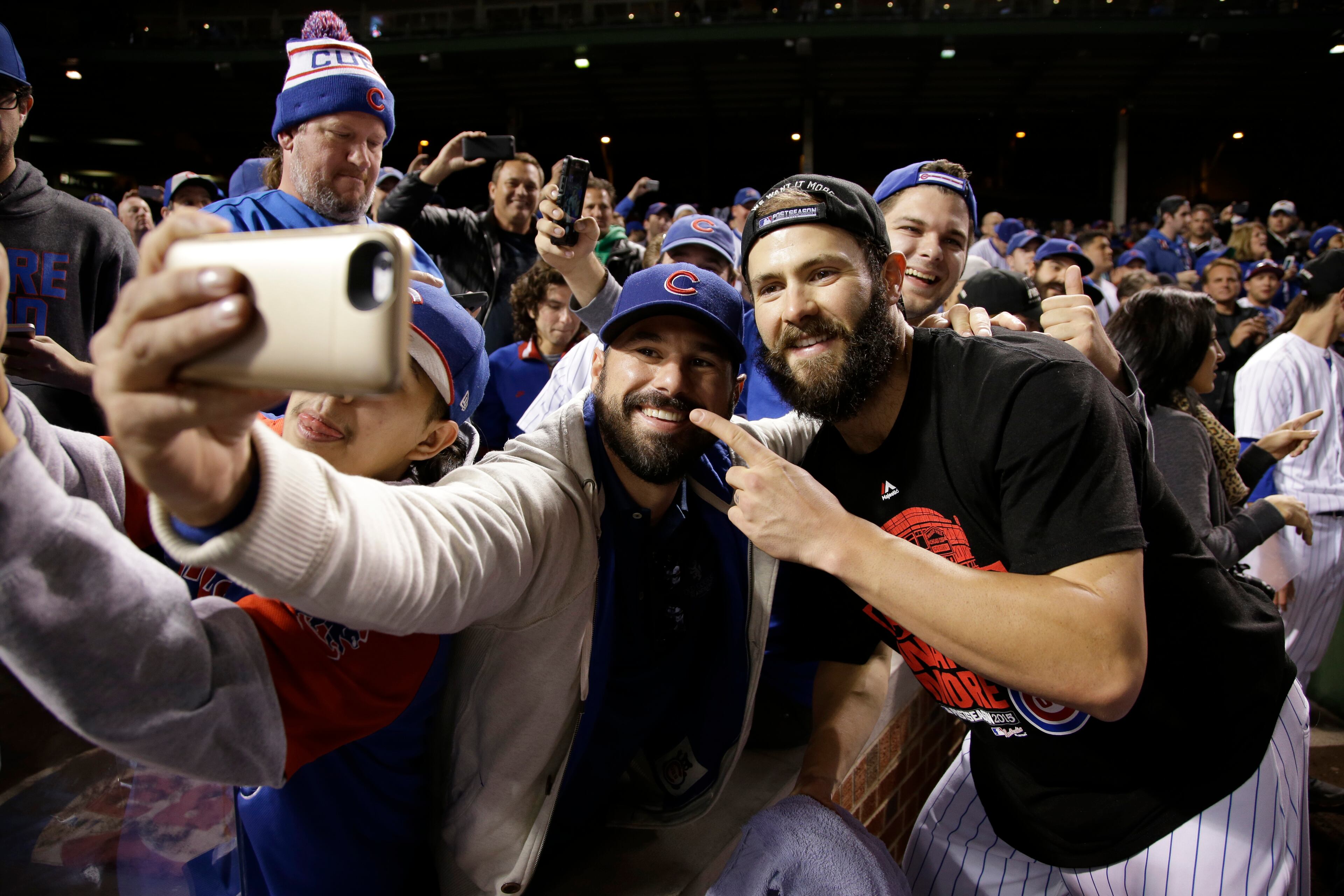 Chicago Cubs starting pitcher Jake Arrieta poses for selfie after the Cubs won 6-4 in Game 4 in baseball's National League Division Series against the St. Louis Cardinals, Tuesday, Oct. 13, 2015, in Chicago. (AP Photo/Nam Y. Huh)