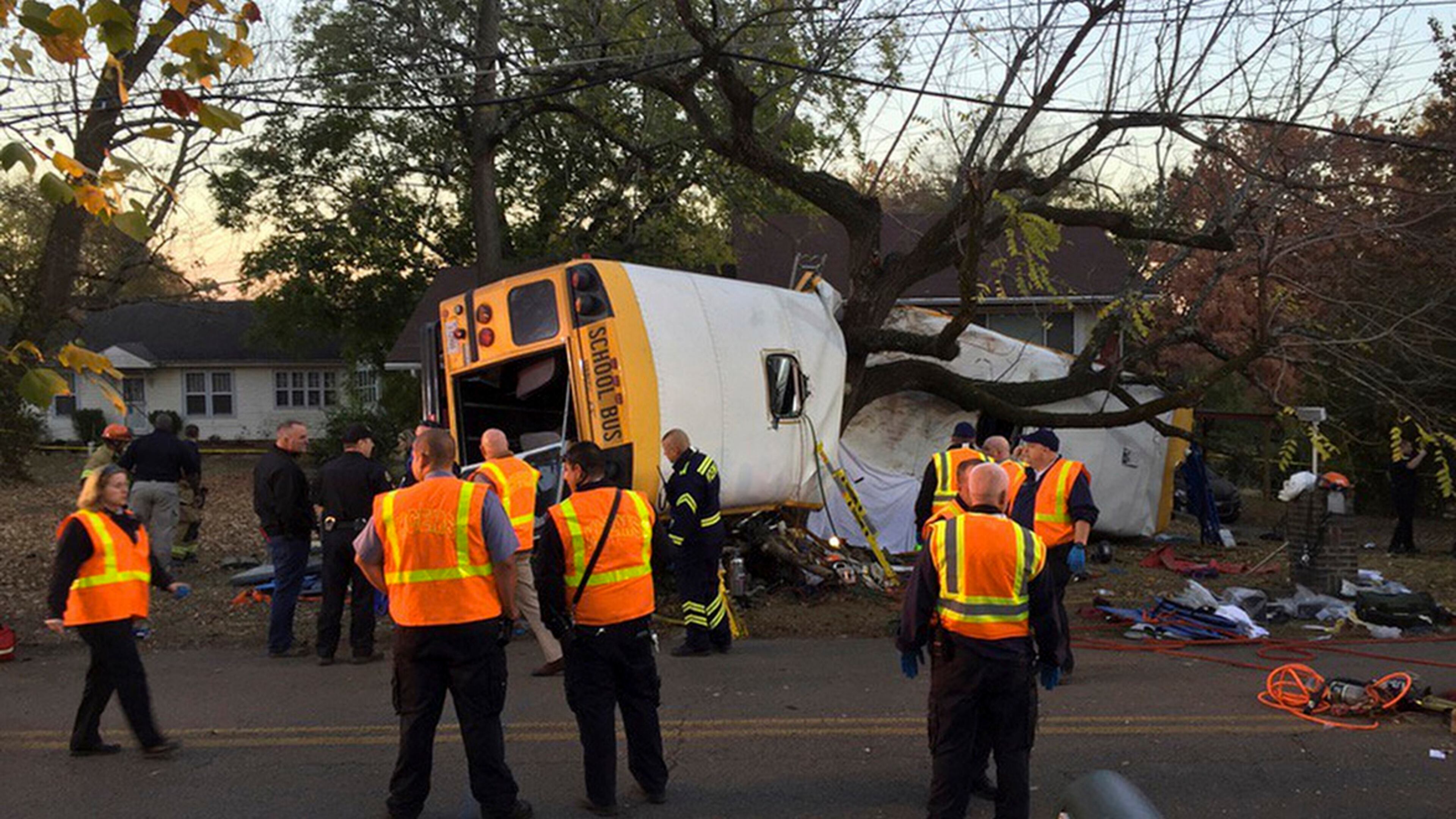 In this photo provided by the Chattanooga Fire Department via Chattanooga Times Free Press, Chattanooga Fire Department personnel work the scene of a fatal elementary school bus crash in Chattanooga, Tenn., Monday, Nov. 21, 2016. In a news conference Monday, Assistant Chief Tracy Arnold said there were multiple fatalities in the crash. (Bruce Garner/Chattanooga Fire Department via Chattanooga Times Free Press via AP)