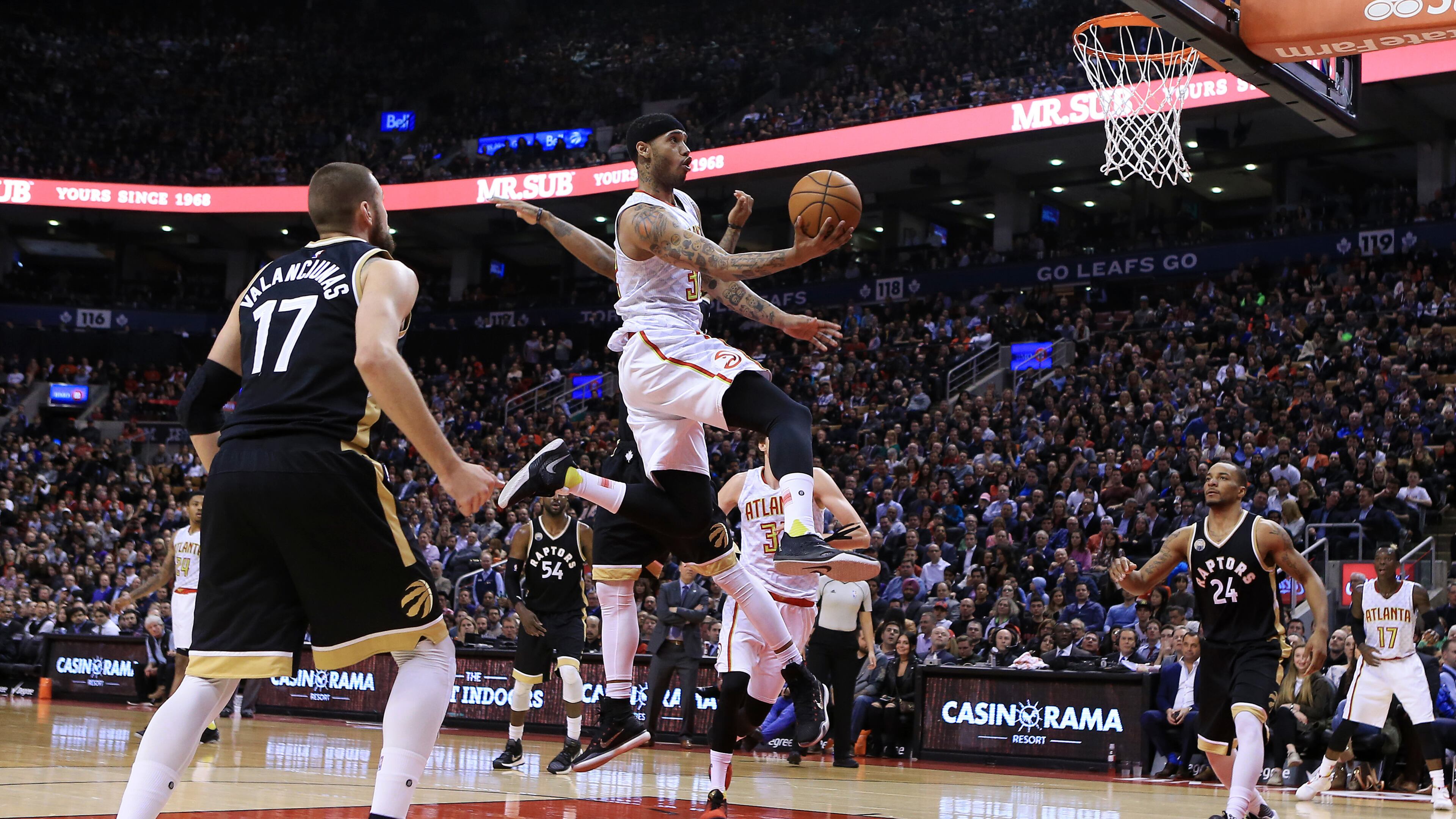 Mike Scott of the Atlanta Hawks drives to the basket against the Toronto Raptors defend during the second half of an NBA game at the Air Canada Centre on March 30, 2016 in Toronto, Ontario, Canada. (Photo by Vaughn Ridley/Getty Images)