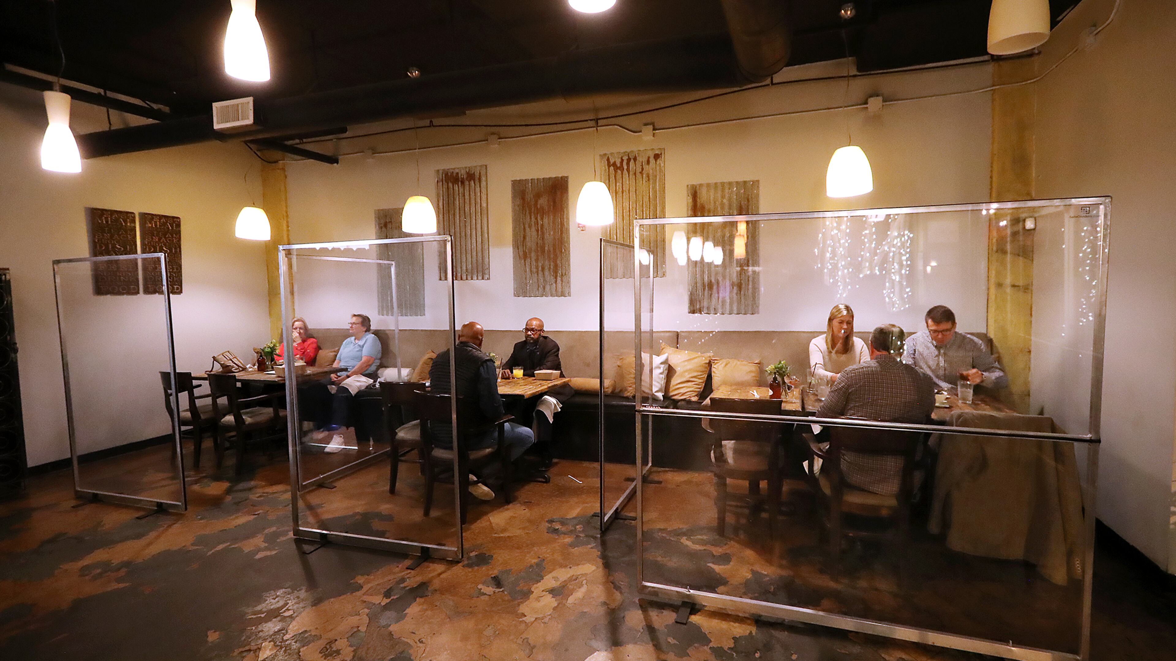 Diners fill plexiglass cubicles during the busy time of day, though busy is relative during a pandemic, at the peak dinner hour in Twisted Soul Cookhouse, on Wednesday, Dec. 9, 2020, in Atlanta. The U.S. Small Business Administration (SBA) recently announced details regarding the $28.6 billion Restaurant Revitalization Fund (RFF) created to help restaurants, bars and other eligible businesses recover from the economic downturn caused by the COVID-19 pandemic. (Curtis Compton / Curtis.Compton@ajc.com)