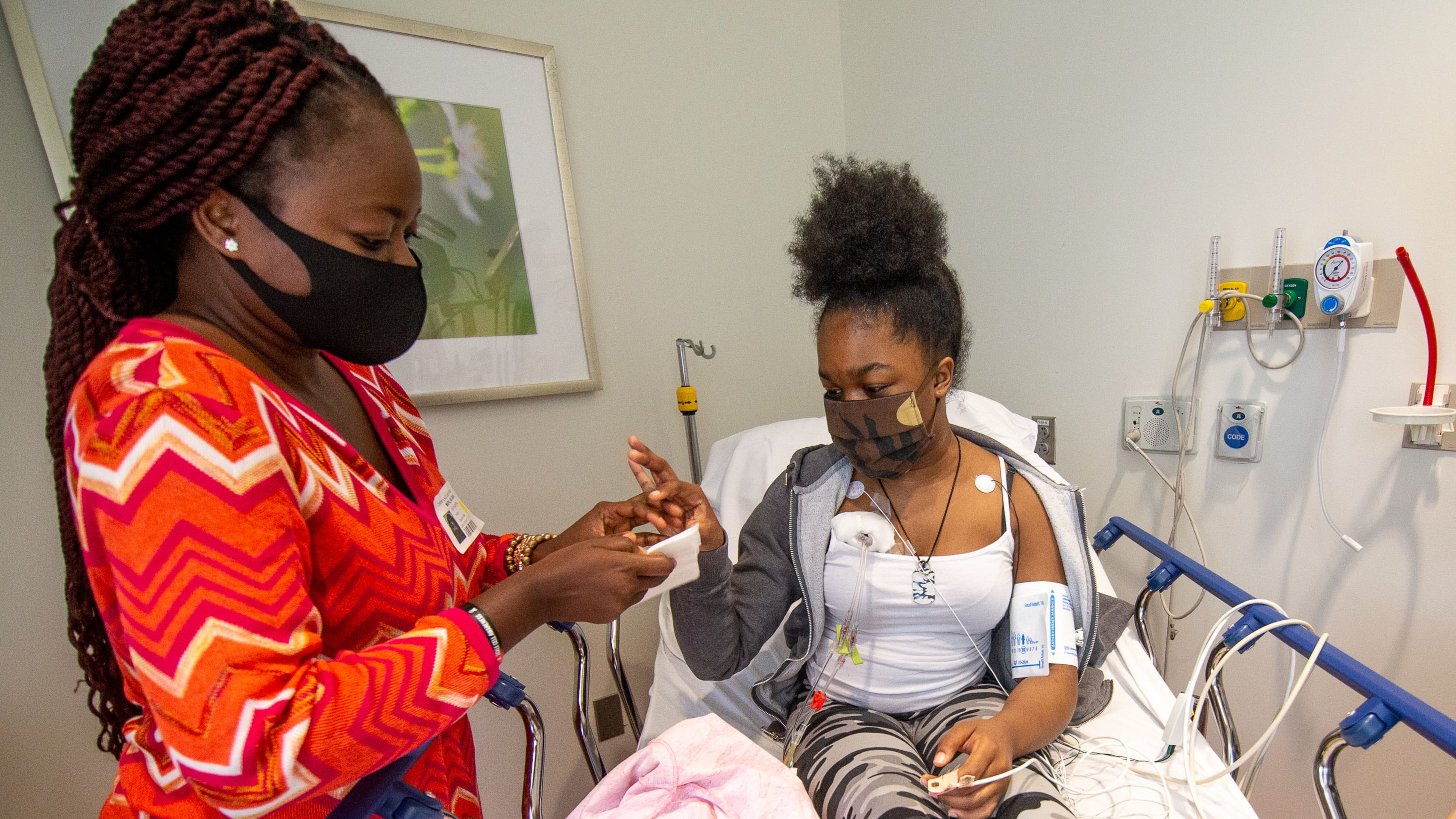 Mapillar Dahn talks with her daughter Khadeejah Tyler, 15, while she undergoes her sickle cell anemia treatment at the Scottish Rite Children's Hospital in Atlanta. STEVE SCHAEFER / SPECIAL TO THE AJC