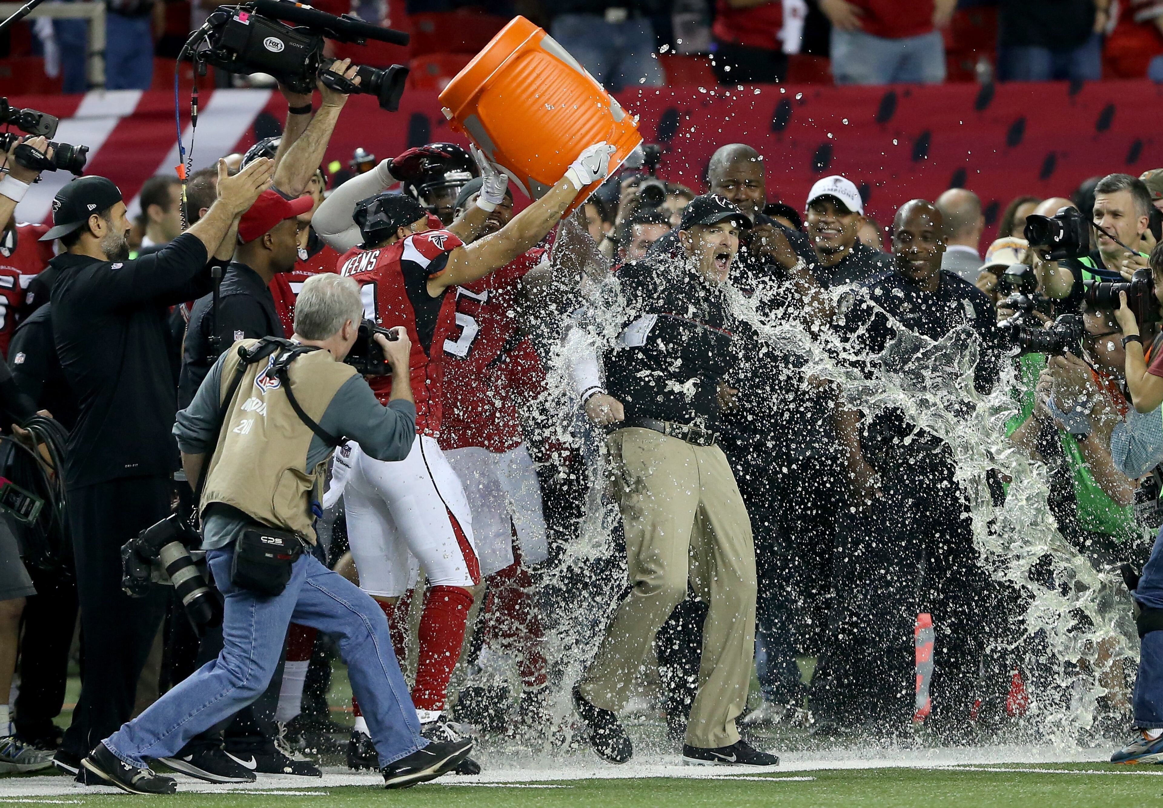 ATLANTA, GA - JANUARY 22: Head coach Dan Quinn of the Atlanta Falcons has gatorade dumped on him by his team late in the game against the Green Bay Packers in the NFC Championship Game at the Georgia Dome on January 22, 2017 in Atlanta, Georgia. (Photo by Streeter Lecka/Getty Images)