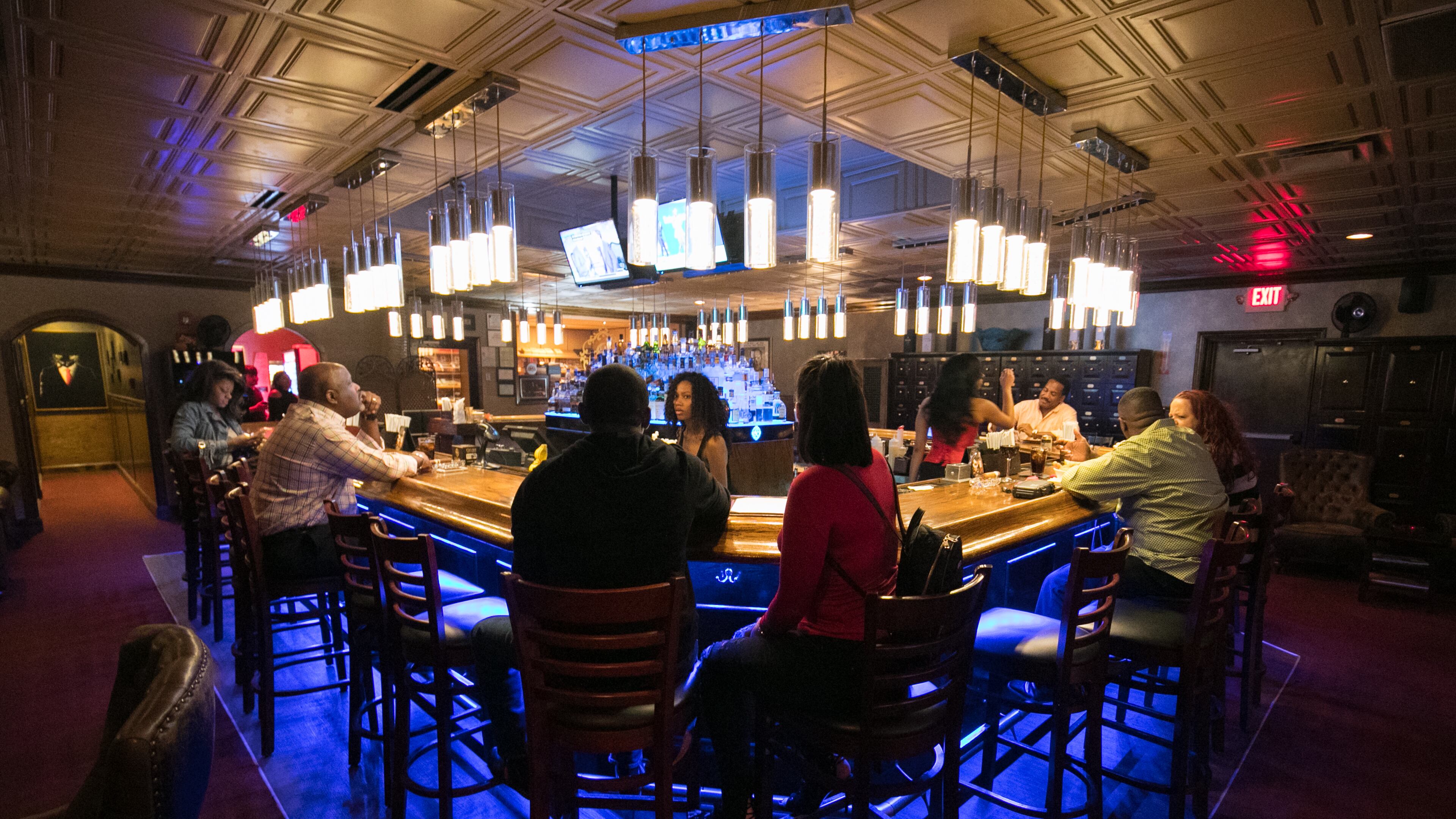A 2017 image of patrons seated at the bar at Cigar City Club in Sandy Springs. Photo credit: JASON GETZ