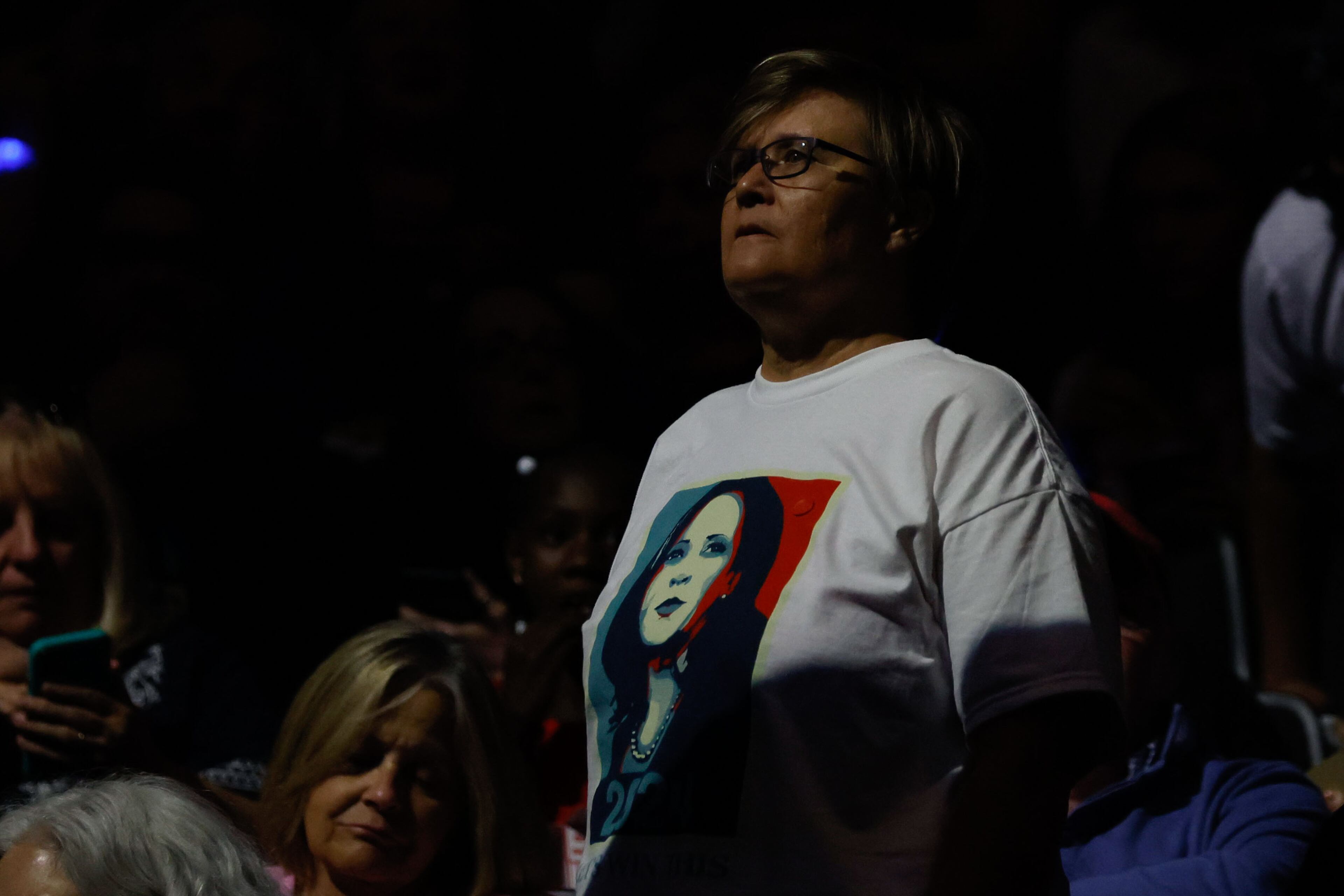 A woman wearing a Kamala Harris shirt observes as the attendees for Vice President Kamala Harris and her running mate start filling up the seats for a campaign rally at Fiserv Forum on Tuesday, August 20, 2024.
(Miguel Martinez / AJC)