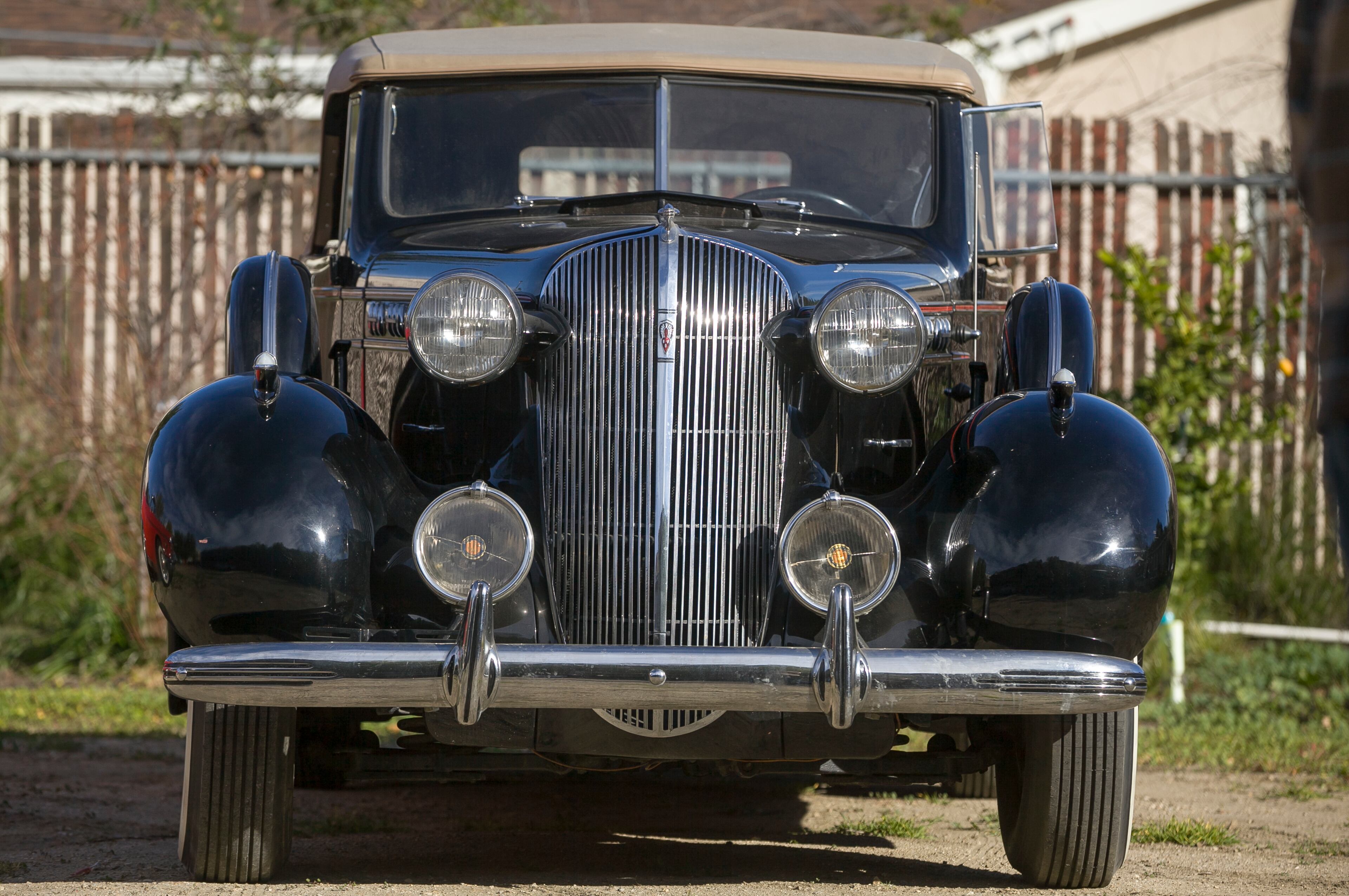 In this photo taken Monday, Jan. 7, 2013, car collector Garvin Kotzin's vintage black 1936 Oldsmobile convertible with a tan ragtop featured in the "Gangster Squad" film, is seen in Los Angeles. To bring the story of mobster Mickey Cohen's reign over post-war Los Angeles to life, the director of "Gangster Squad" employed Sean Penn, Josh Brolin, Ryan Gosling and more than 100 irreplaceable vintage American cars. There's the 1941 light blue Ford Deluxe Convertible that Gosling's character drives; the bulbous, bullet-nosed 1947 Ford sedans that served as police cars; the gorgeous black 1936 Oldsmobile convertible with a tan ragtop and the regal 1949 Packard Super 8 limousines that carried Cohen.