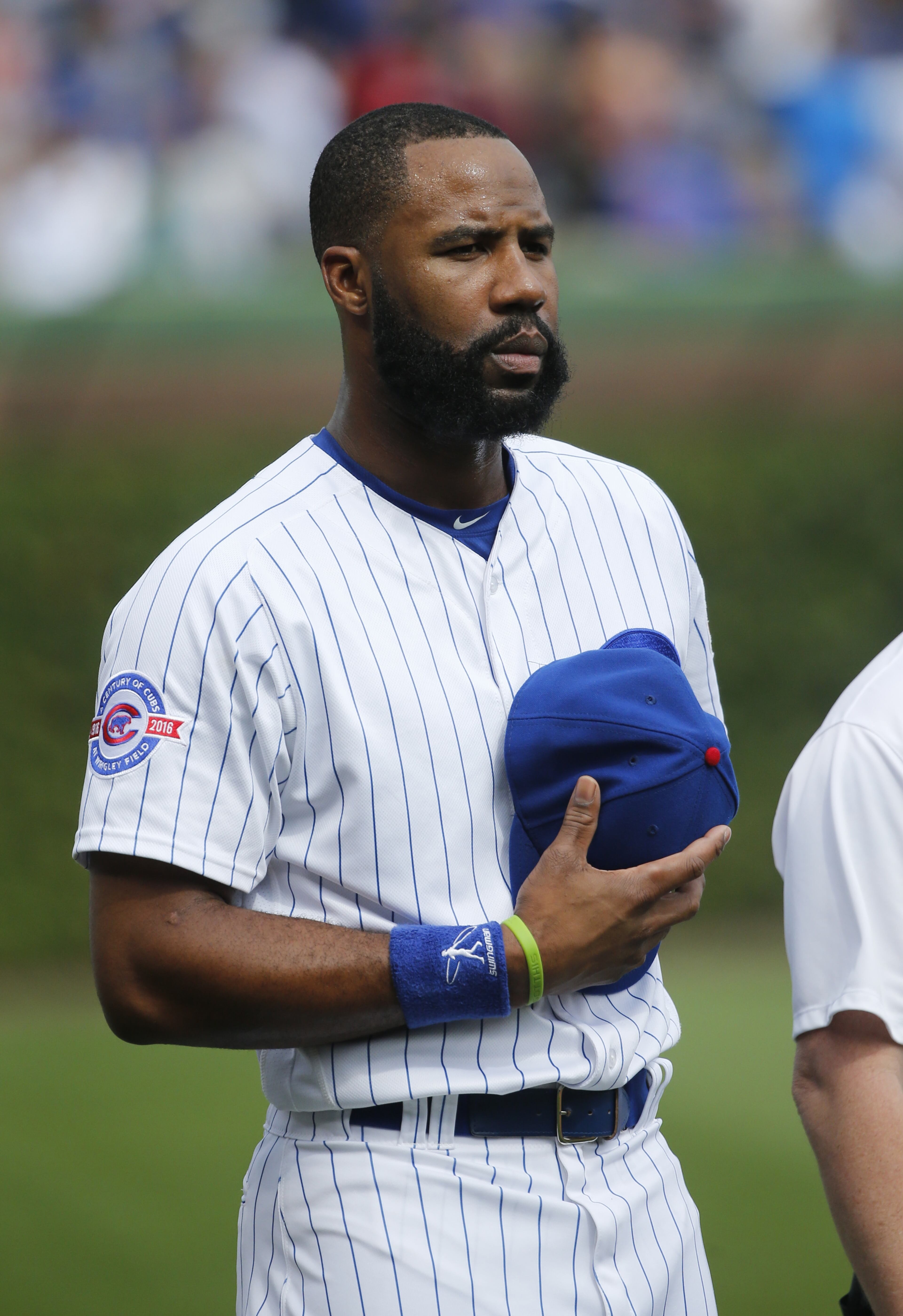 Chicago Cubs' Jason Heyward listens to the national anthem before a baseball game against the St. Louis Cardinals Friday, Sept. 23, 2016, in Chicago. (AP Photo/Charles Rex Arbogast)