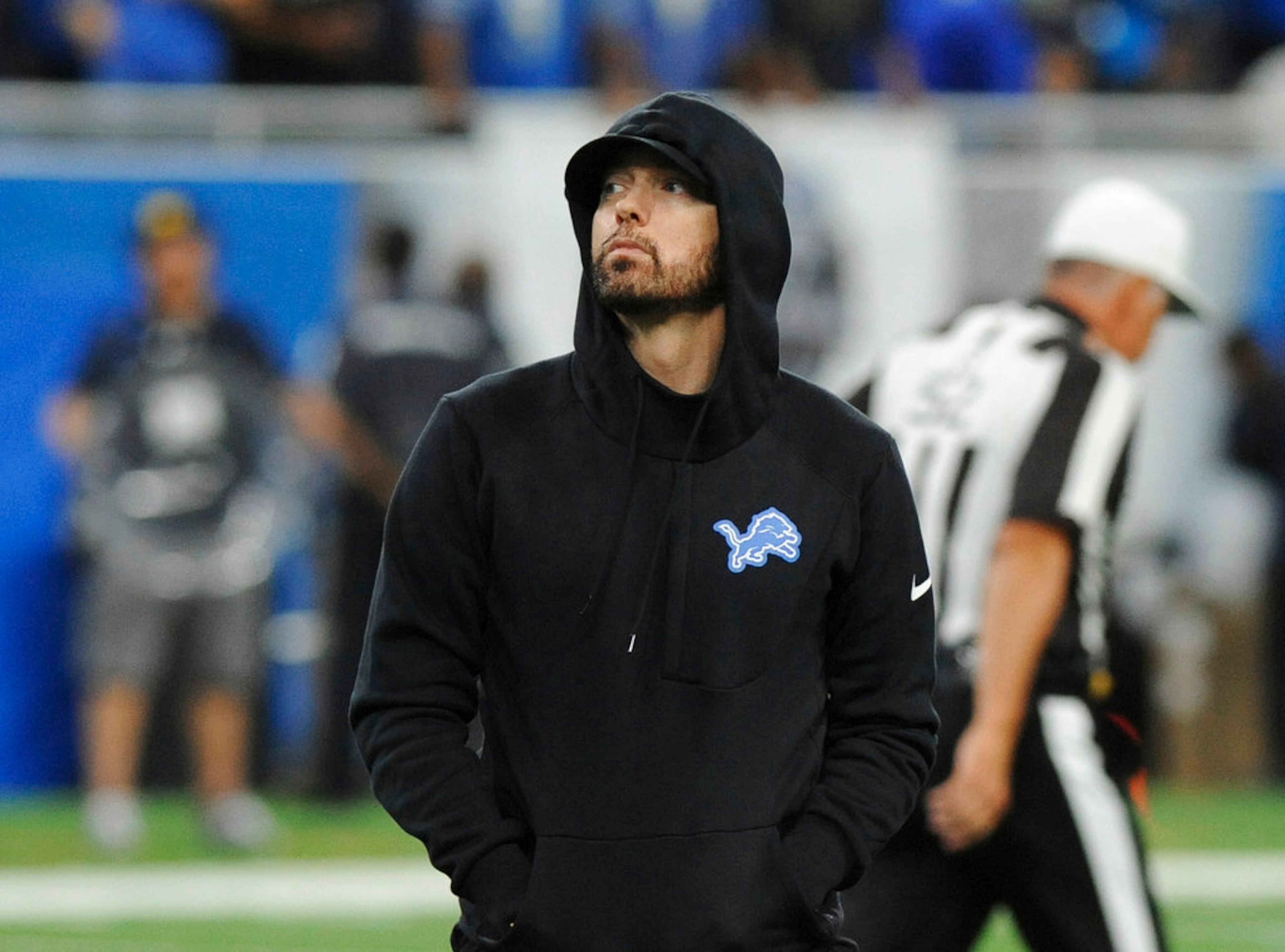 Eminem walks off the field at an NFL football game between the Detroit Lions and New York Jets in Detroit, Monday, Sept. 10, 2018. (AP Photo/Jose Juarez)