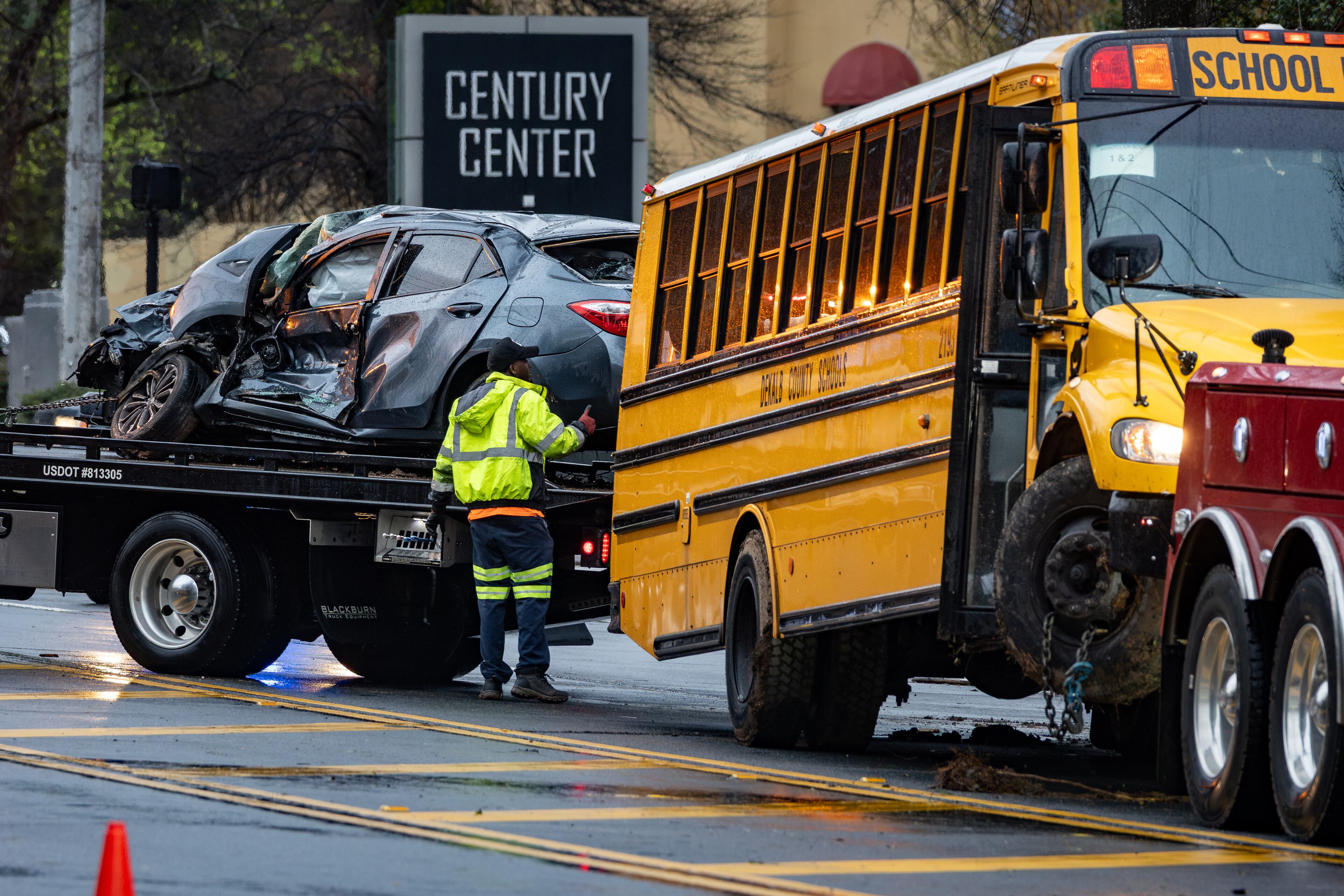 A Dekalb County School bus is loaded onto a tow truck along with a passenger car following an accident on Clairmont Road. Thursday, March 12, 2026 (Ben Hendren for the AJC)
