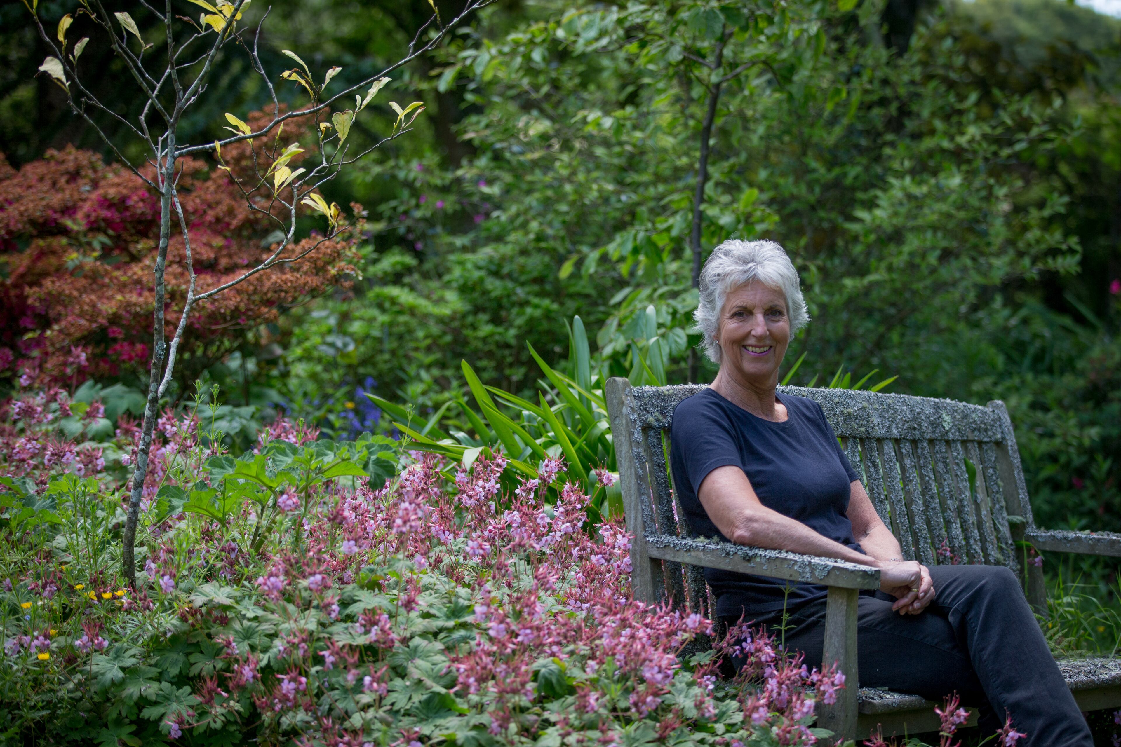 PENZANCE, ENGLAND - JUNE 03: Penny Lally owner of the Penwith Pet Crematorium, pet cemetery and memorial gardens sits on a memorial bench at the Penwith Pet Crematoruim near Penzance on June 3, 2015 in Cornwall, England. Established in 1988 as a pet cemetery and pet crematorium for dogs, cats and small animals, more recently they have opened a horse cemetery and also woodland and natural burial grounds for people wishing to be buried close where their beloved animal's ashes were scattered or interred. Globally the pet cremation and burial, or 'pet loss' industry has boomed recently, as many bereaved pet owners look to give their much loved pets more individual, formal and dignified send-offs. (Photo by Matt Cardy/Getty Images)