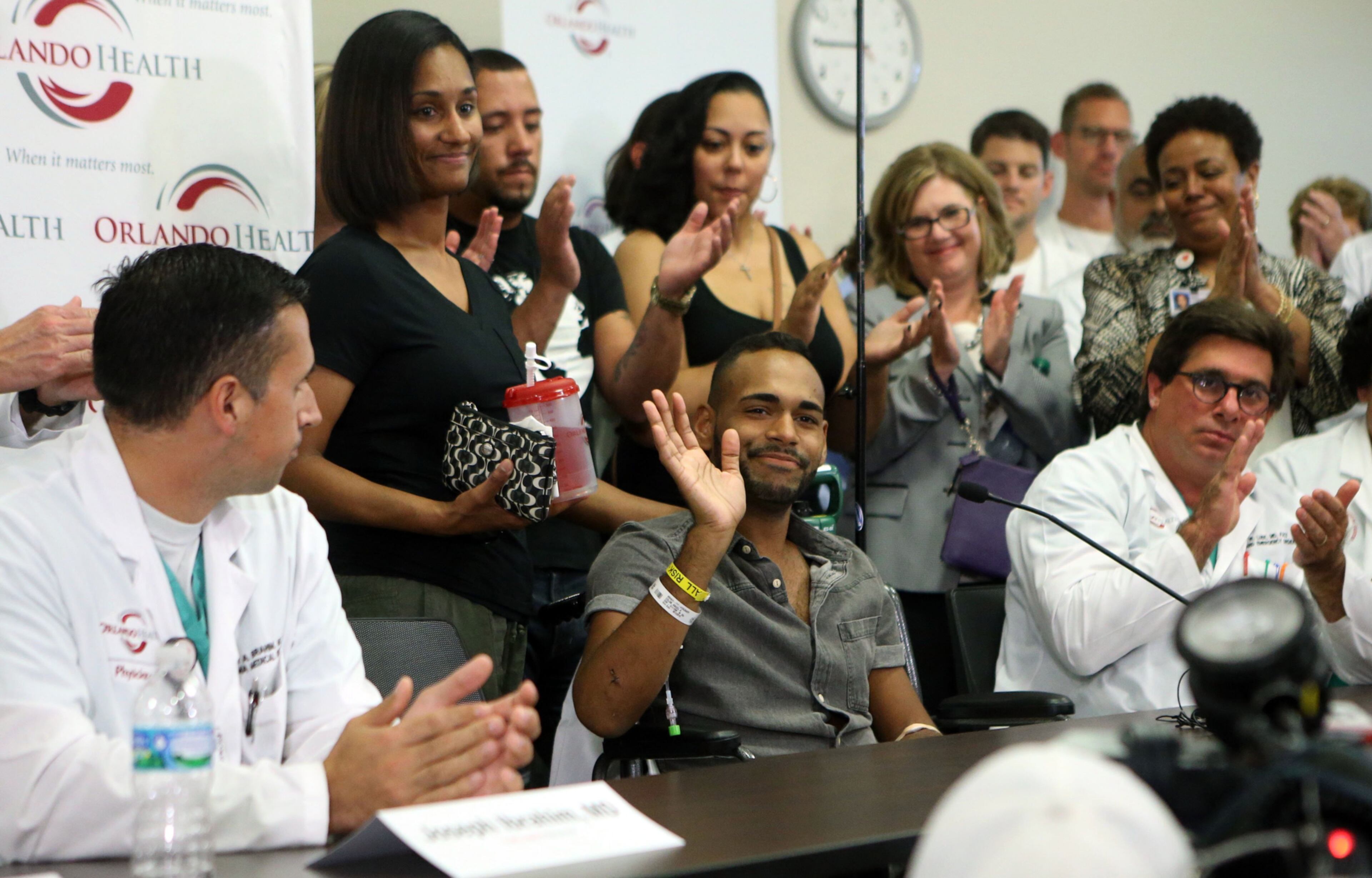 SHOOTING SURVIVOR SPEAKS--Angel Colon waves to supporters during a Tuesday press conference at Orlando Regional Medical Center where 44 patients were taken. Nine of them died. Photo: Curtis Compton